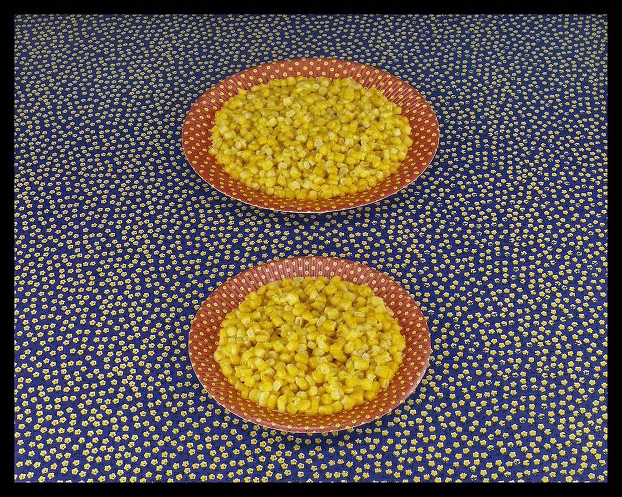 Sandy Skoglund Color Photograph - Two Plates of Corn