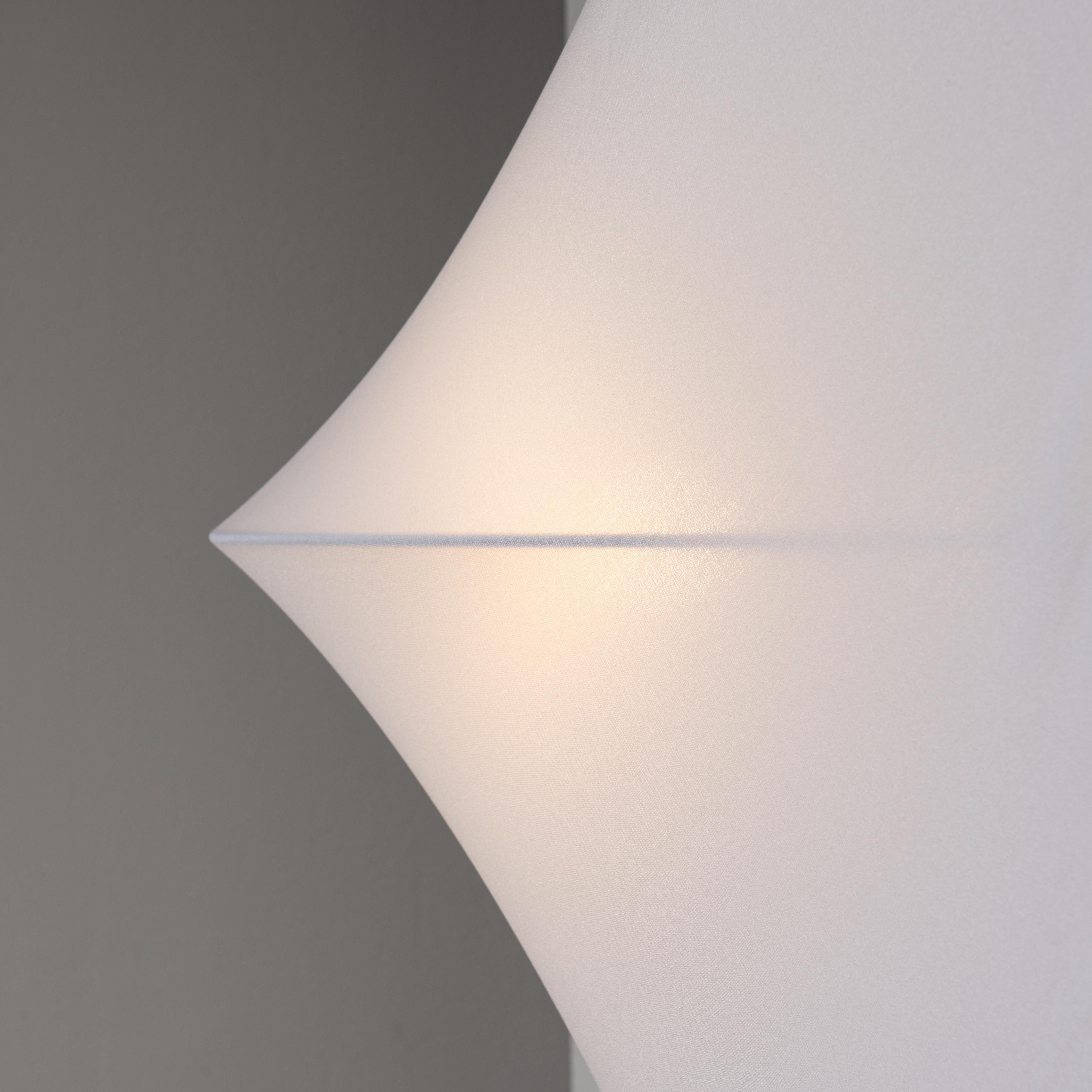 Sanka 2 Wall Light  by Kazuhide Takahama for Sirrah. Designed and manufactured in Italy, circa the 1970s. Dead-stock from Sirrah. Triangular plastic frame and stretch fabric cloth diffuser. This model variation can be mounted as a sconce, or corner