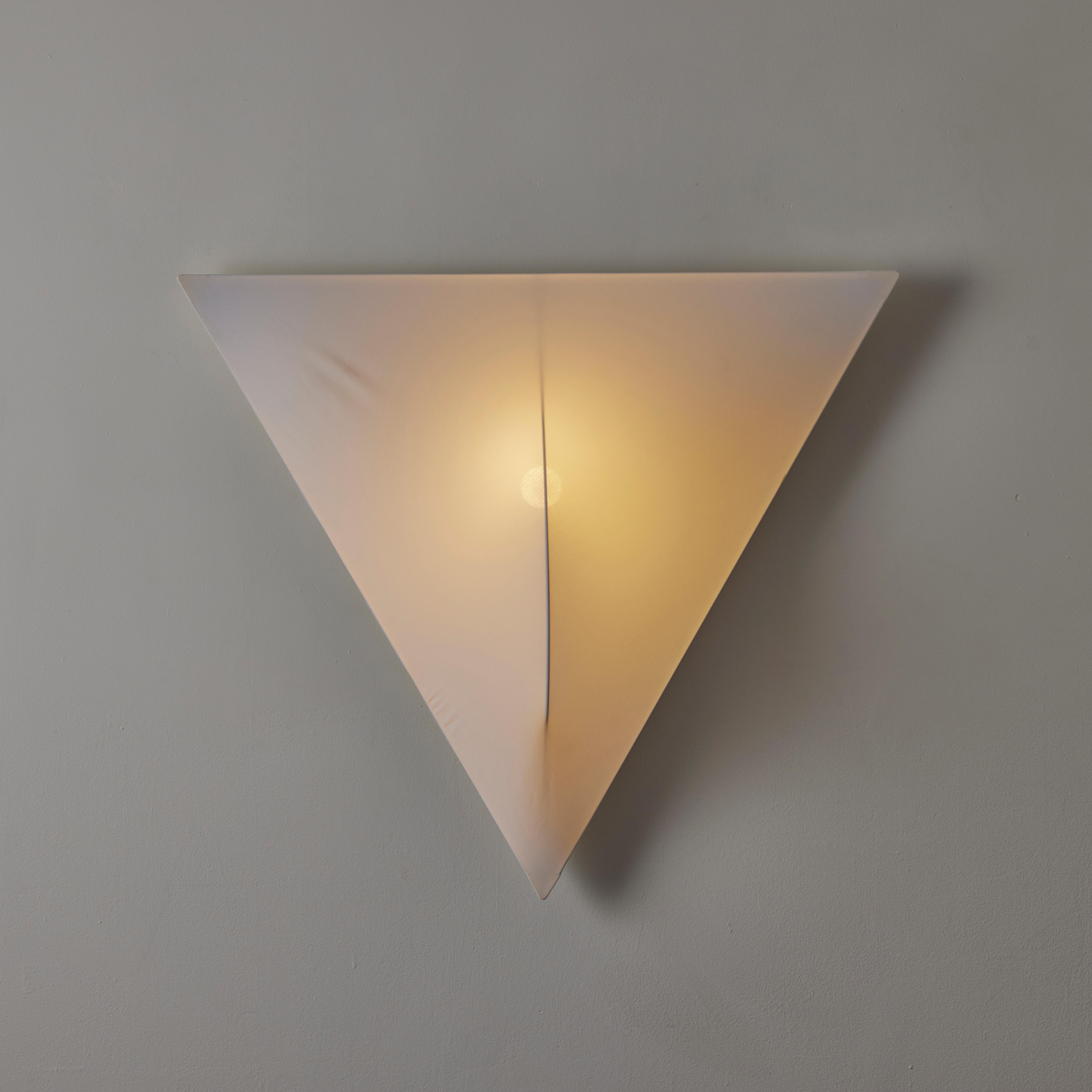 Sanka 2 Wall Light  by Kazuhide Takahama for Sirrah. Designed and manufactured in Italy, circa the 1970s. Dead-stock from Sirrah. Triangular plastic frame and stretch fabric cloth diffuser. This model variation can be mounted as a sconce, or corner