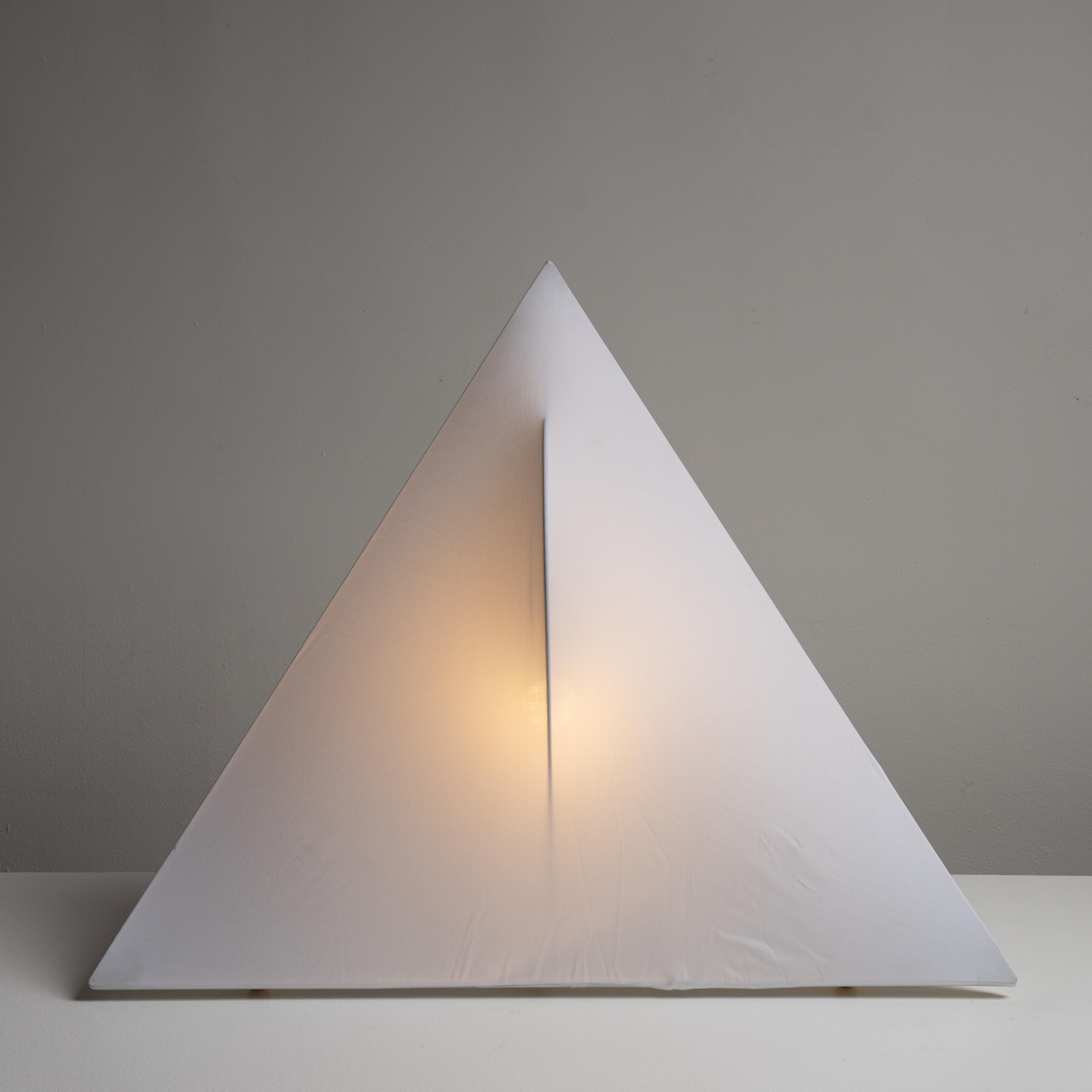 Sanka Table or Floor Lamp by Kazuhide Takahama for Sirrah. Designed and manufactured in Italy, circa the 1970s. Dead-stock from Sirrah. Triangular plastic frame and stretch fabric cloth diffuser. The lights hold a single E27 socket type, adapted for