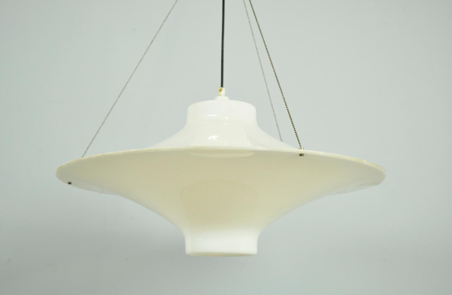 Beautiful classic timeless pendant lamp model “Sky Flyer/Lokki” designed by Yki Nummi for Sanka, Finland 1959. The lamp is made of white semi-transparent acrylic and hangs on three metal wires. The lamp consists of two halves that are connected to