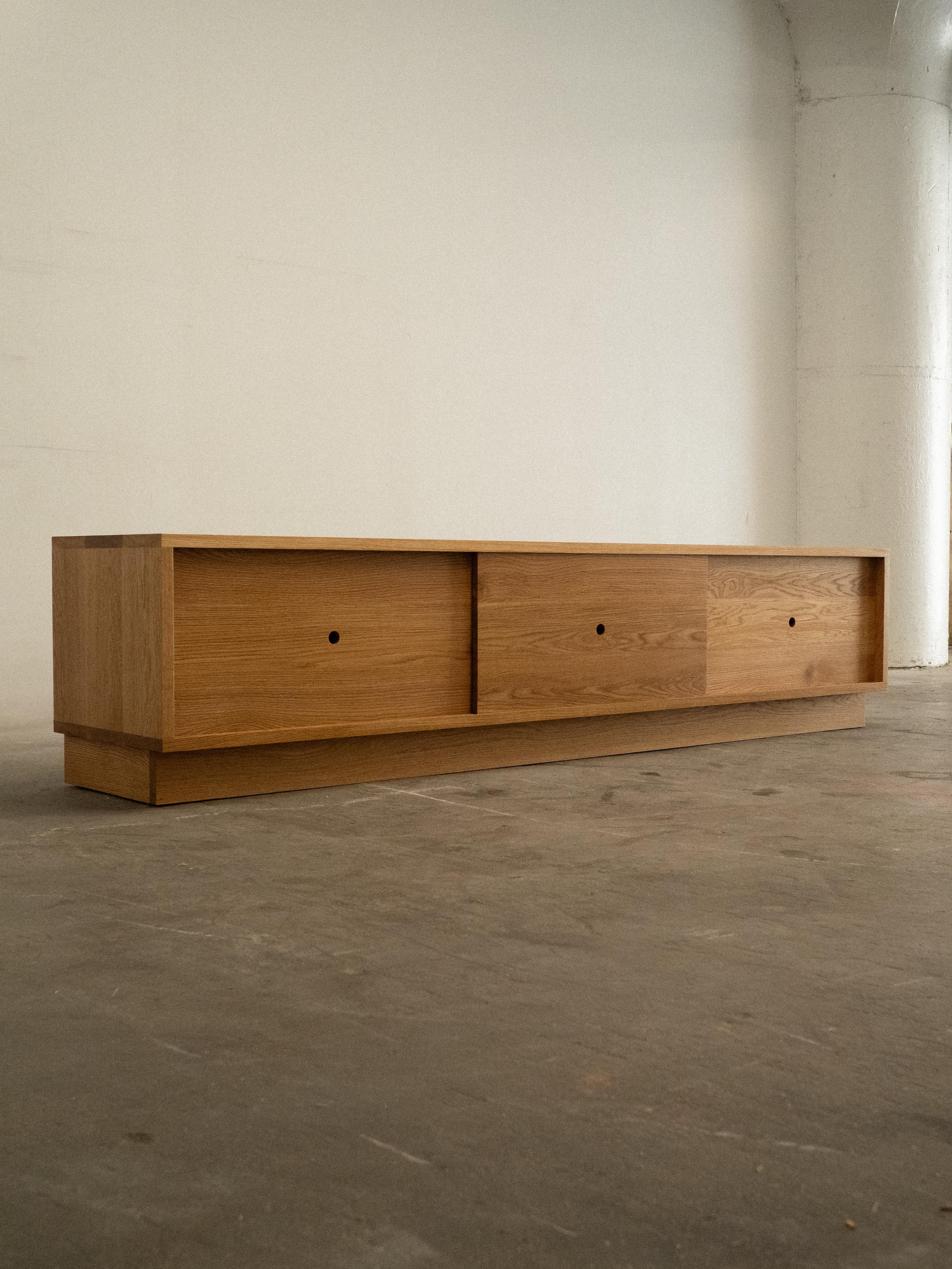 This beautifully crafted solid oak media unit or sideboard draws inspiration from timeless Japanese proportions. Made from high-quality, locally sourced white oak, it’s finished with eco-friendly Osmo wood oil to enhance the rich, natural