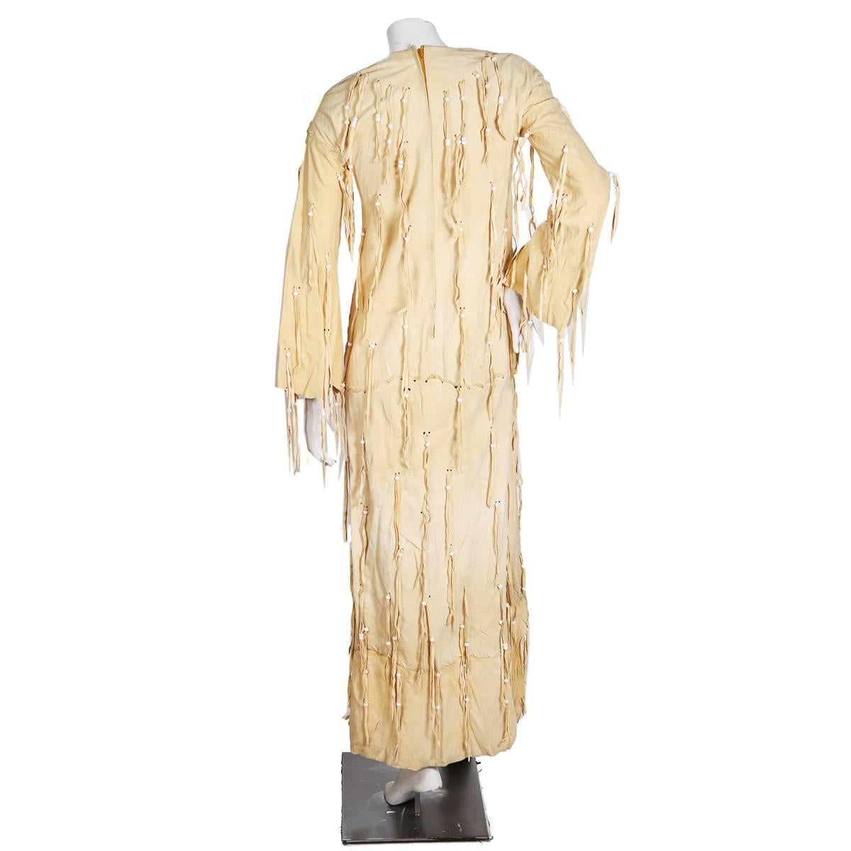 Dress by Giorgio Sant' Angelo circa 1960s/1970s
Beige suede covered in suede string and white bead fringe
Empire waist fit
Condition: Great vintage condition, with some expected but minor wear to the suede due to its age

Size/Measurements:
36