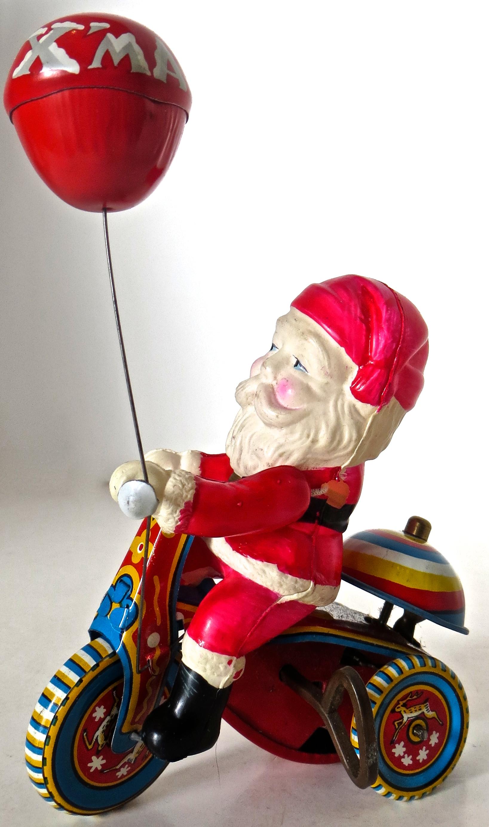 The celluloid Santa and tin tricycle indicate a mid-1950s manufacture for this charming Japanese wind up toy which comes with the original box in which it was shipped. Unlike most examples found of this toy, this example is near mint and operates