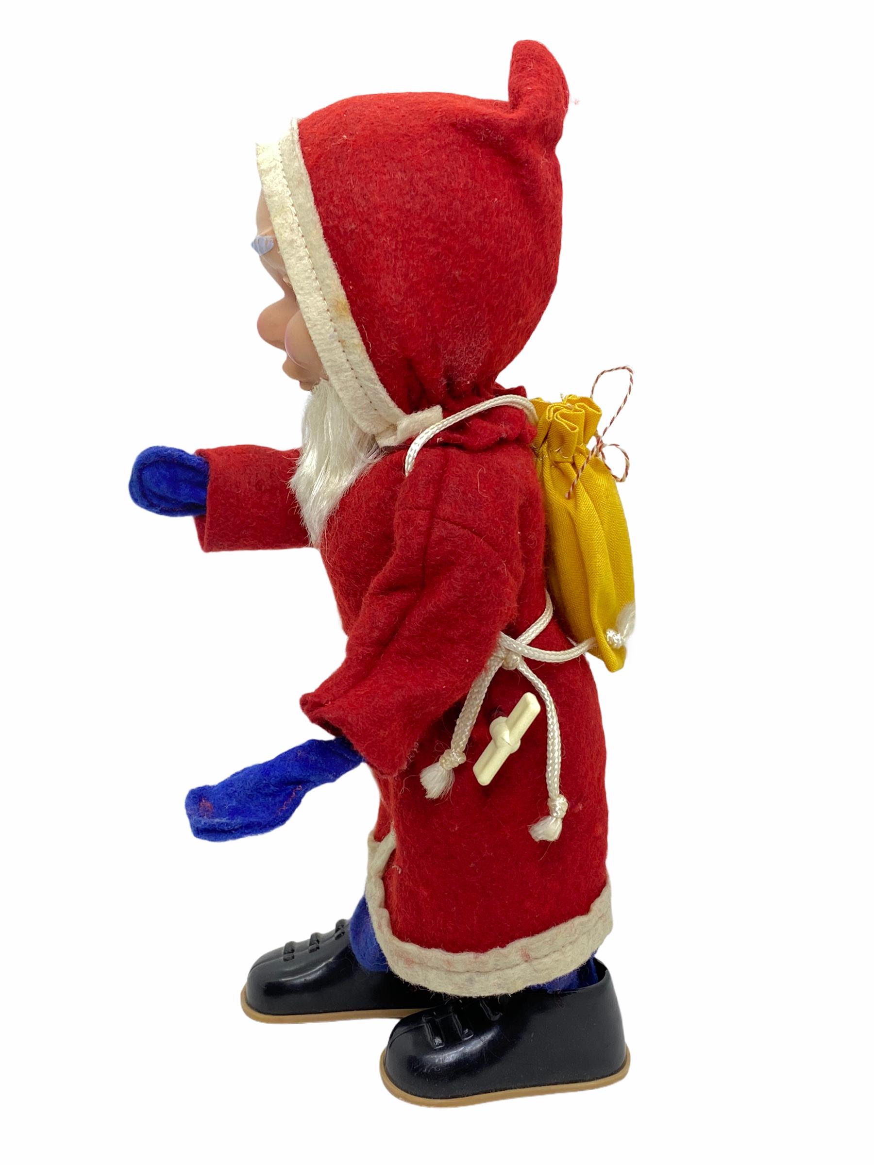 A beautiful German Belsnickle / Santa Claus figure as a wind up toy. Its in working condition. Nice addition to your Christmas collection or decoration. Made probably in the 1960s by a german toy manufactory, marked Western Germany.