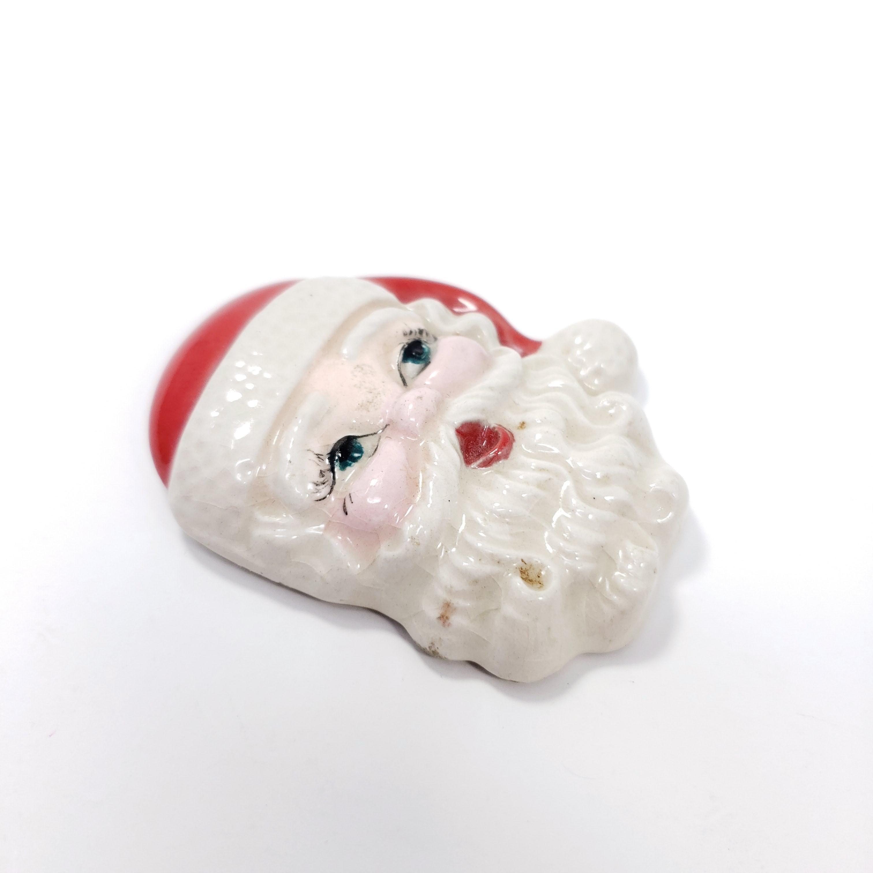 A festive holiday pin, featuring Santa Claus. The perfect touch of Christmas cheer!

Marks / hallmarks / etc: Molly McGuive