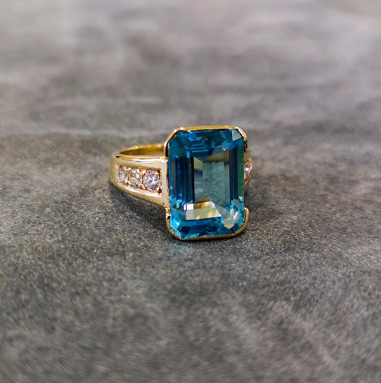  An astonishing, breath-taking 6.00 carat aquamarine featuring beautiful, sparkling blues, synonymous with gems from the famed Santa Maria mine. Mounted in a simple 18-carat yellow gold frame, with tapering shoulders, each set with graduated