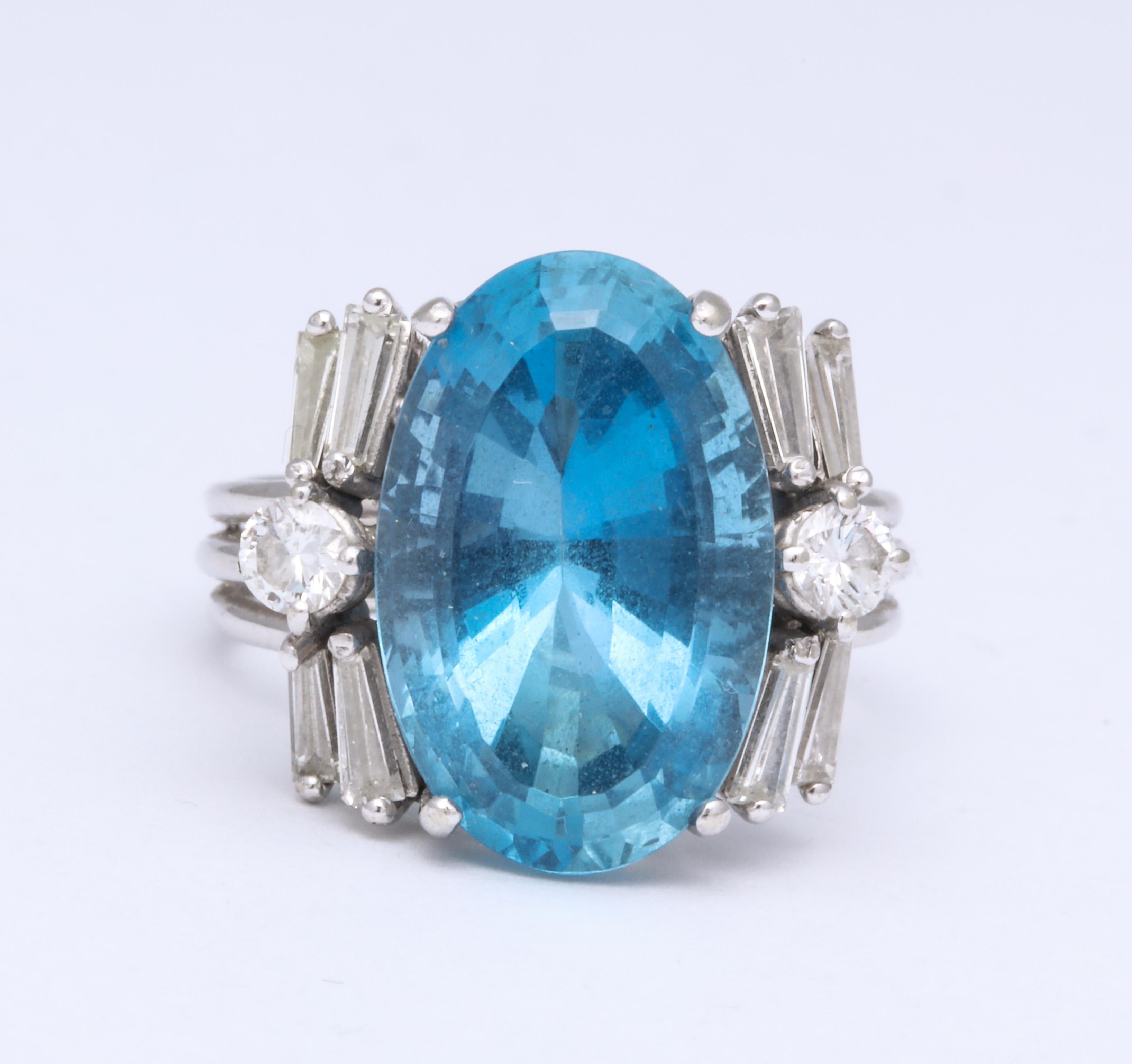 A stunning aquamarine ring from the greatest aqua mine of all time the Santa Maria (now closed) flanked by a combination of round and baguette diamonds in a floral setting. With certificate available.