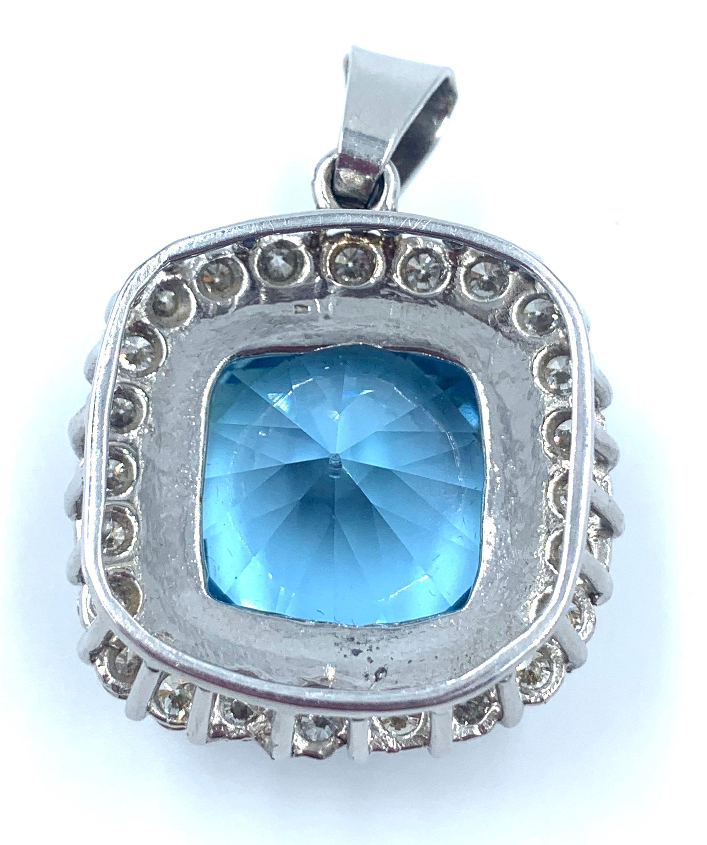 This is gorgeous aquamarine and diamond pendent set in 18K white gold. In the center, an exceptional 53ct aquamarine, originating from the Santa Maria aqua mine in Brazil, known for the finest aquamarines in the world. Framing this rare, very deep