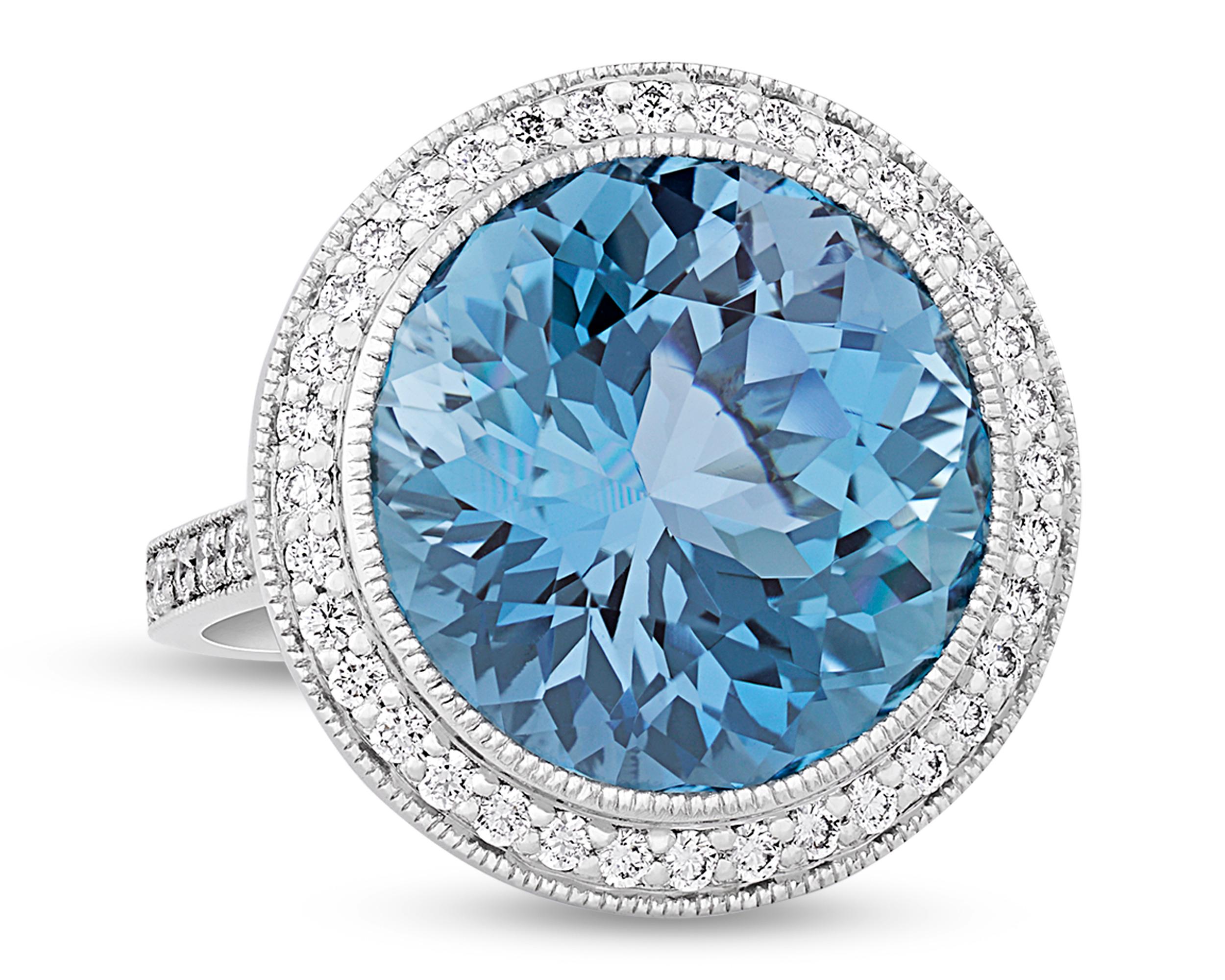 With the stunning blue hue of a clear tropical ocean, the incredible 13.17-carat round brilliant-cut aquamarine at the center of this ring is absolutely captivating. This specimen possesses the deeply saturated Santa Maria blue hue that is found