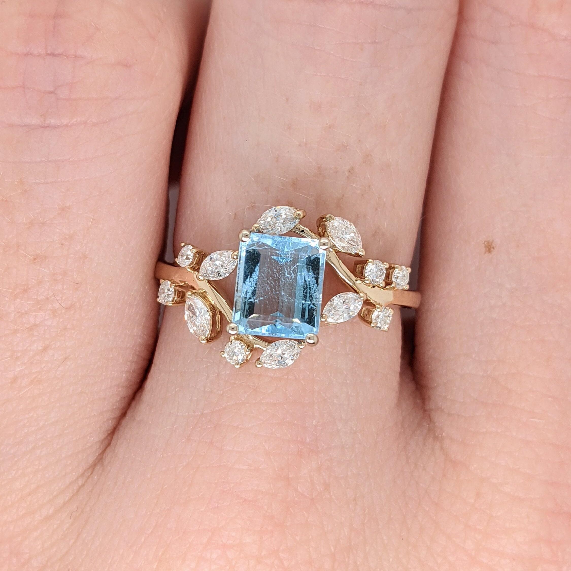A gorgeous sea blue aquamarine from the famed mines of Santa Maria set in a unqie bypass natured theme ring setting in 14k yellow gold with all natural earth mined diamond accents. The perfect engagement ring as well as a graduation or birthday
