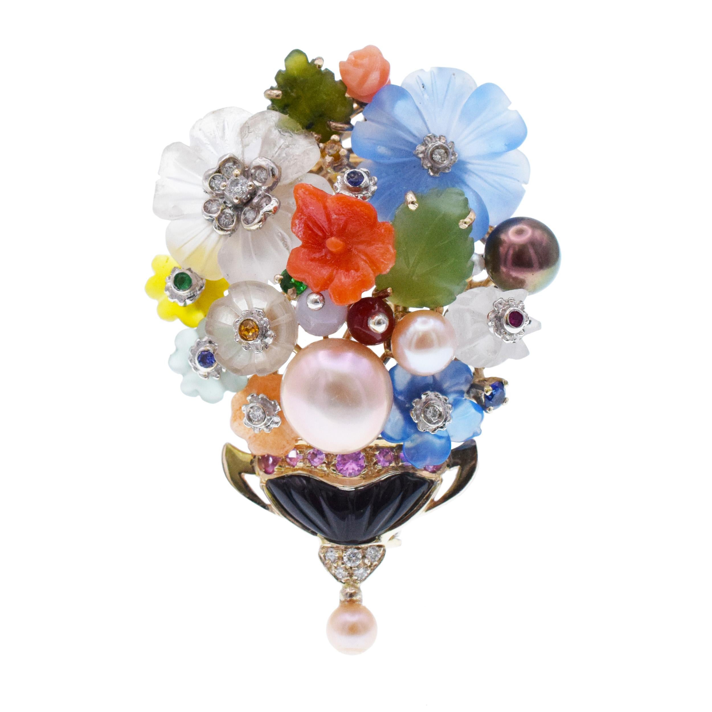 Santagostino Colorful Flower Buquet Brooch/Pendant In
18k White Gold. This radiant brooch/pendant features flowers and vase crafted in carved and round cut multicolor gemstones, accented with white
and black pearls, and round brilliant cut diamonds.