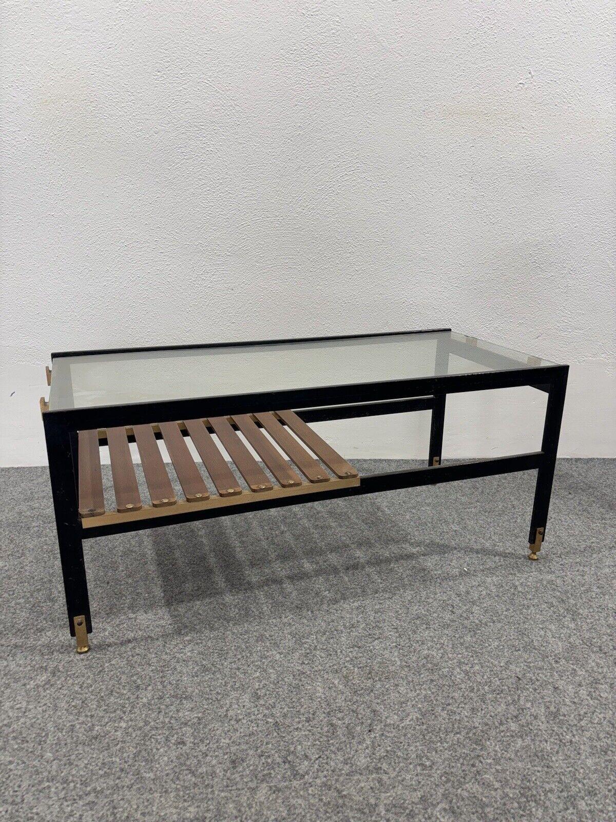 Wonderful wood, metal, brass and glass coffee table , made in the 1960s, Italian manufacture, Sant'Ambrogio and de berti.

The item in good conservative condition, there is no major cosmetic or structural defect to report, only slight and obvious