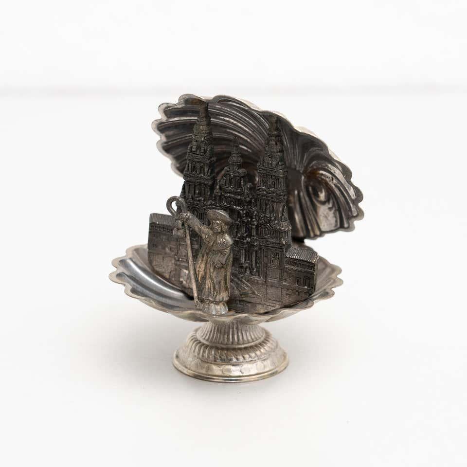 Santiago de Compostela memorabilia metallic figure.    Made Spain, circa 1950.    In original condition, with minor wear consistent with age and use, preserving a beautiful patina.    Materials:  Metal.   