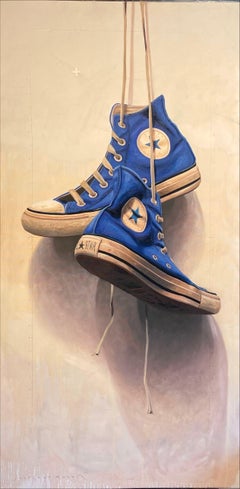"#1611" Still-life of a pair of blue Chuck Taylors hanging by their laces