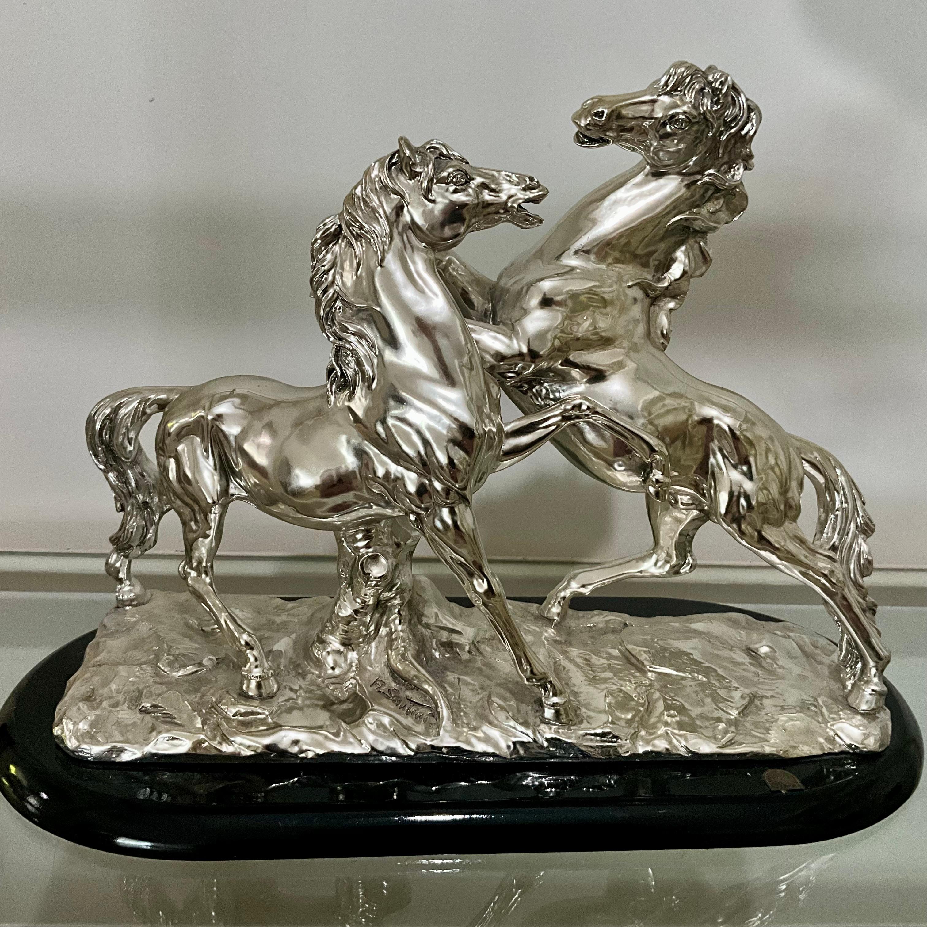 Title:
Santini Silvered Resin Sculpture of Two Rearing Horses, Signed, Italy Mid-20th Century

Highlight:
Large Italian Santini sculpture of two rearing stallions, silver finish over resin, mounted on a black base — bold mid-century equestrian