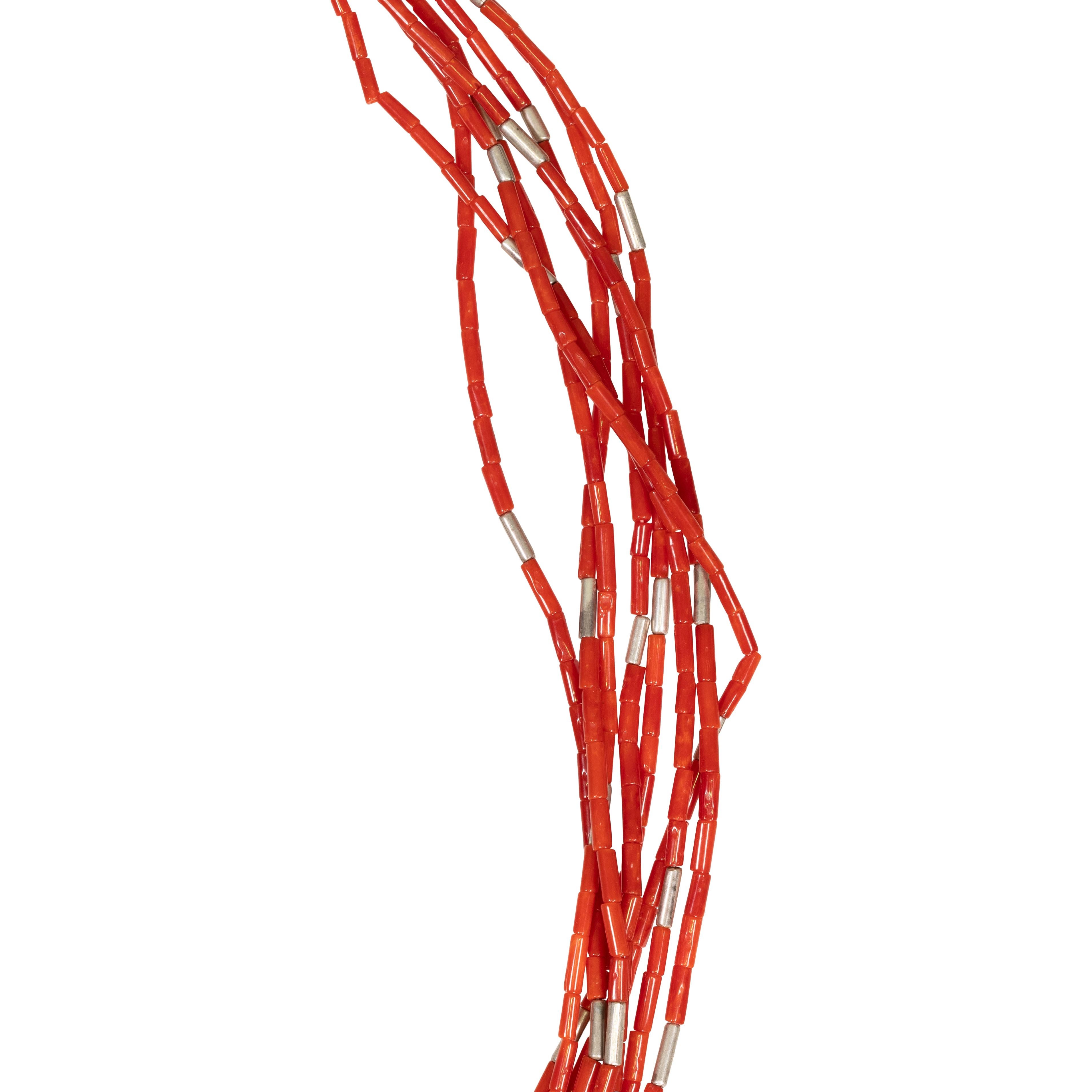 Santo Domingo beaded coral necklace. Featuring eight strands strung with coral and sterling having traditional cord wrapping. Beads are exceptionally small and fine with deep scarlet coloring. Would make the perfect finishing touch for a casual or