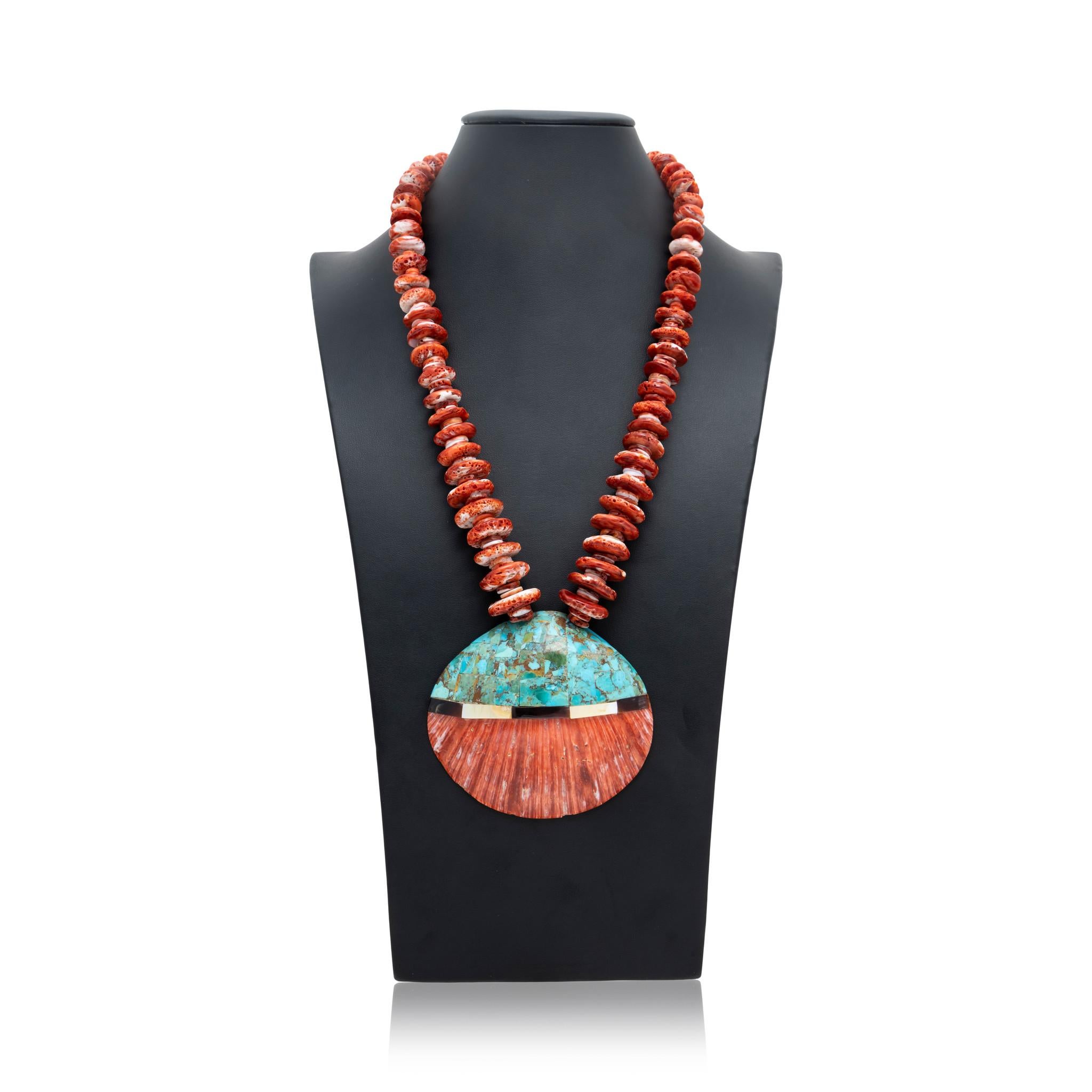 Native American Santo Domingo Indian burnt orange spiny oyster necklace. Piece has beaded chain with large and small round spiny oyster beads, featuring large shell pendant inlaid with Kingman turquoise, mother of pearl and onyx. Traditional Santo