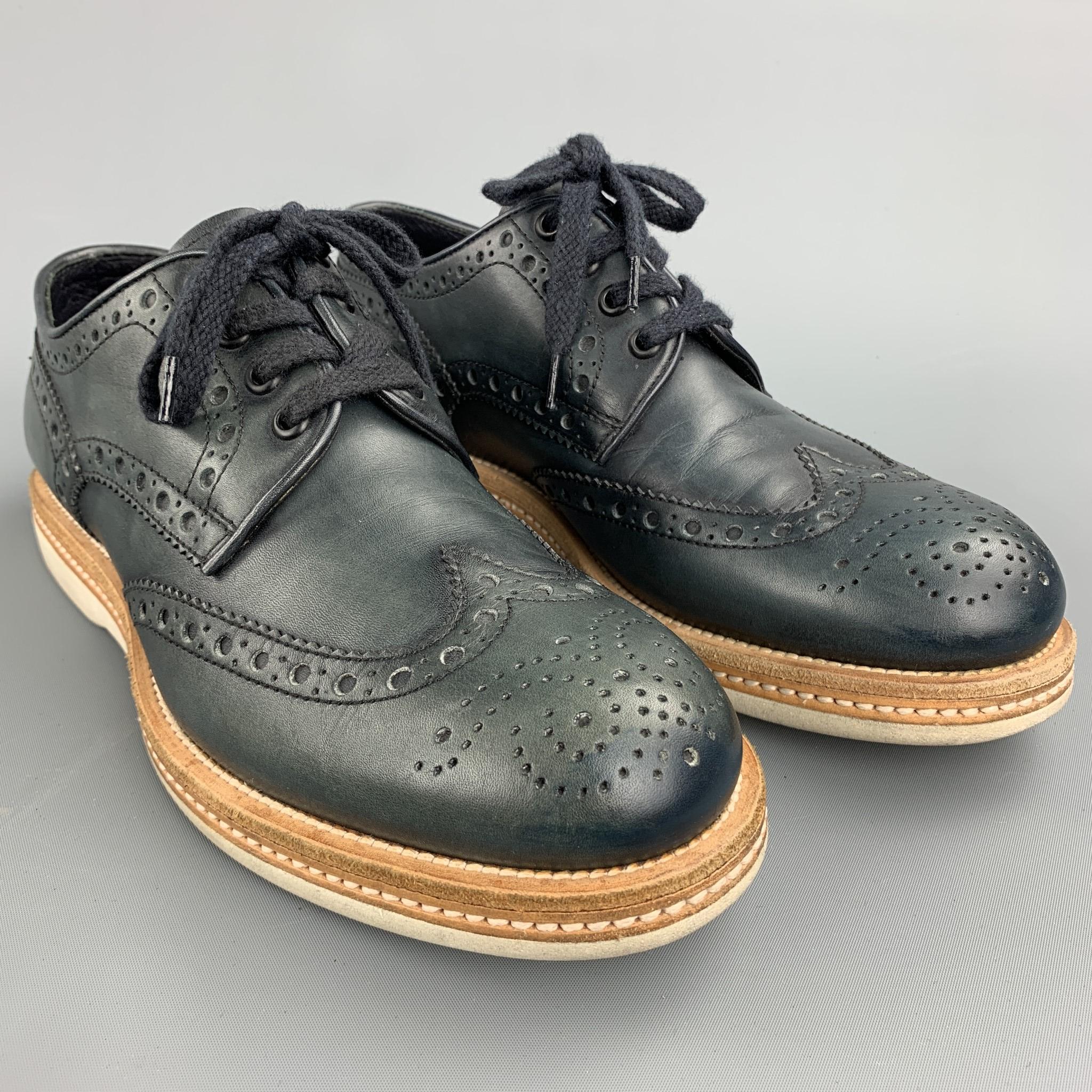 SANTONI lace up shoes comes in a navy perforated leather featuring a wingtip, contrast stitching, a rubber sole. Minor wear on the sole. Made in Italy.

Good Pre-Owned Condition.
Marked: 7 F

Outsole:
 
11 in. x 4 in. 