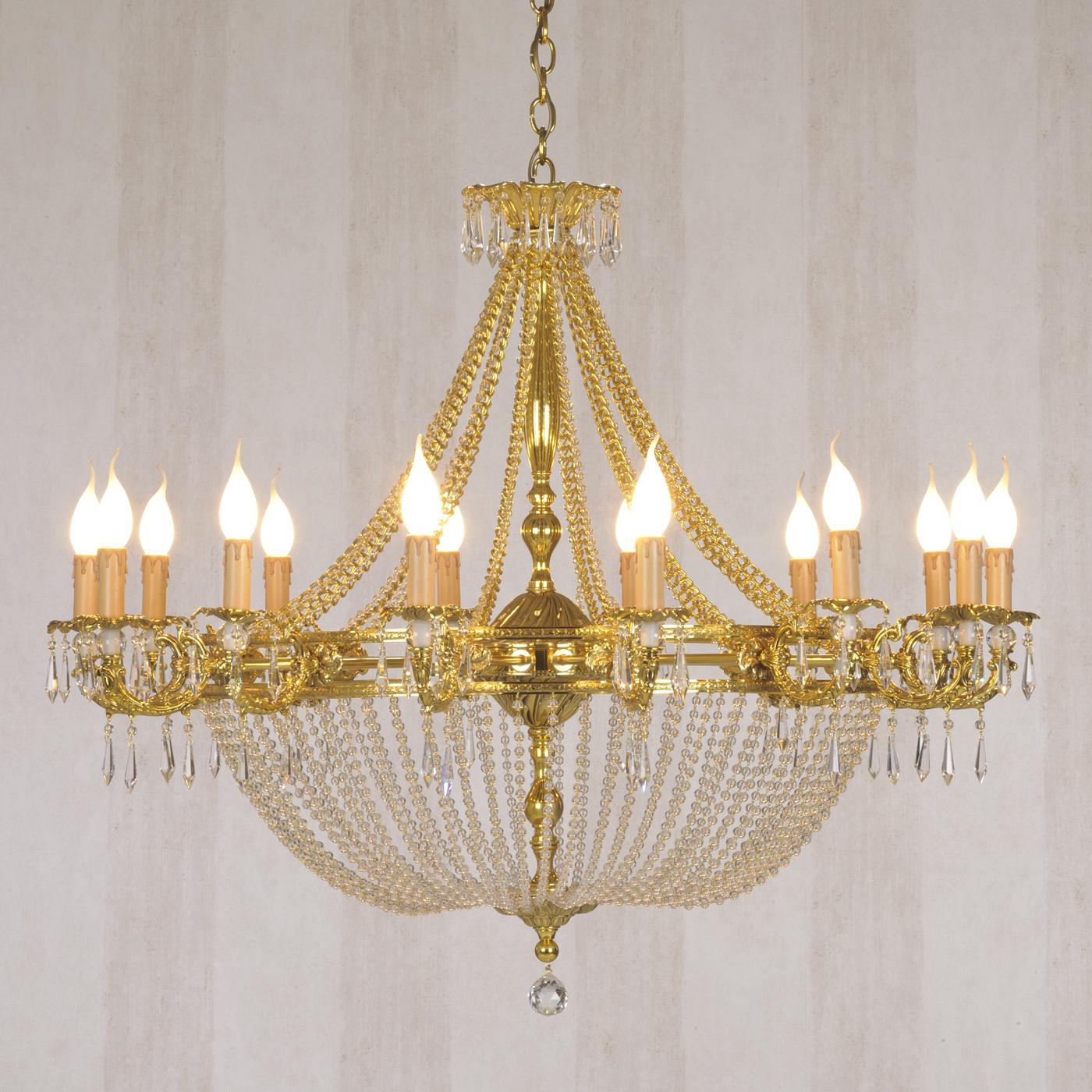 This striking chandelier features a central structure in bronze with a French gold finish, from which 14 arms stem, supporting 14 lights. Pendant crystal decorations adorn the piece throughout, from the top round element to the lights and from them