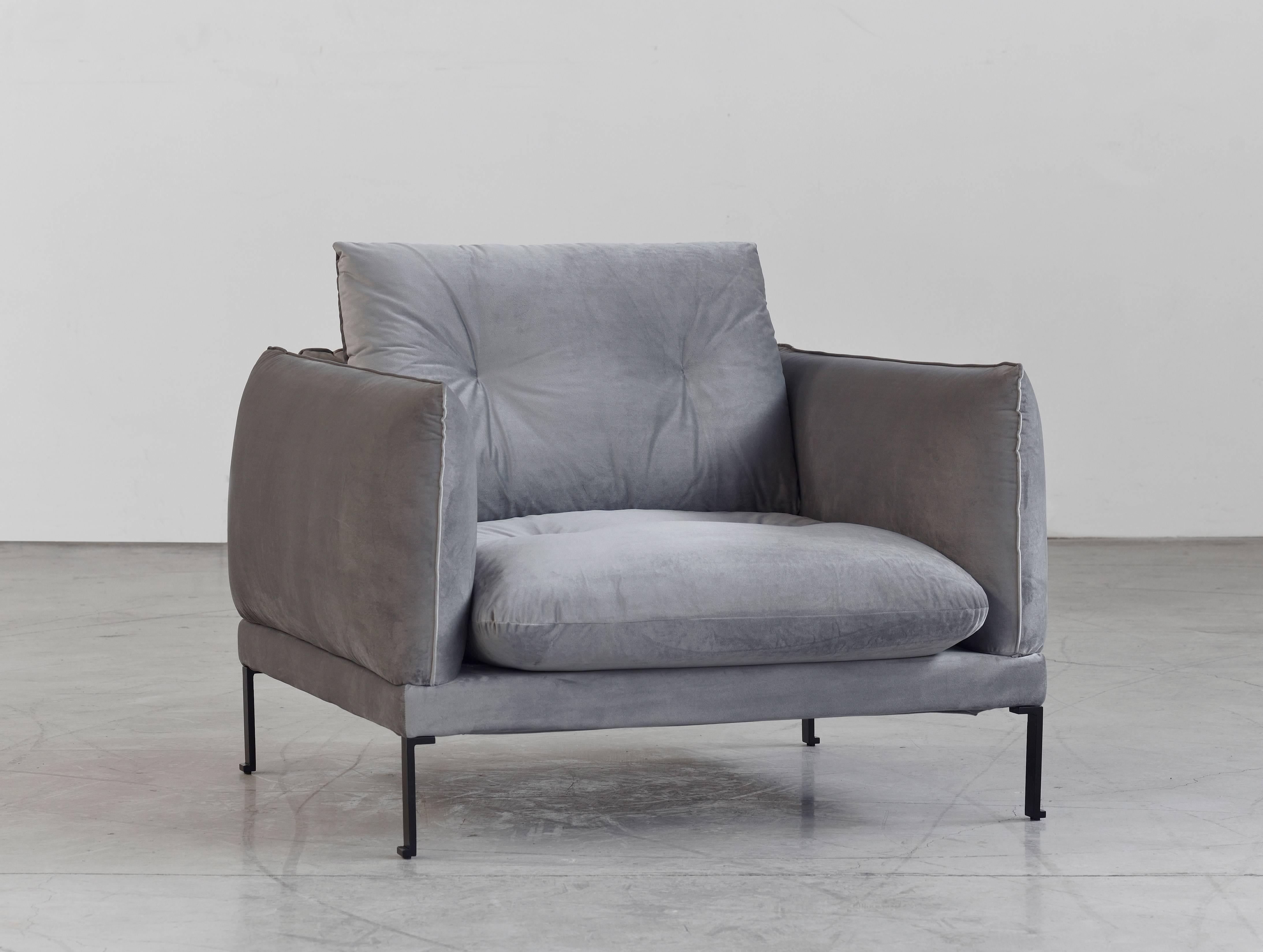 Santorini is an inviting armchair with flowing lines and rounded edges, inspired by the curvilinear architectural forms found at the Cycladic Santorini Island, in Greece. It's a piece of modern clean silhouette, which provides maximum softness and