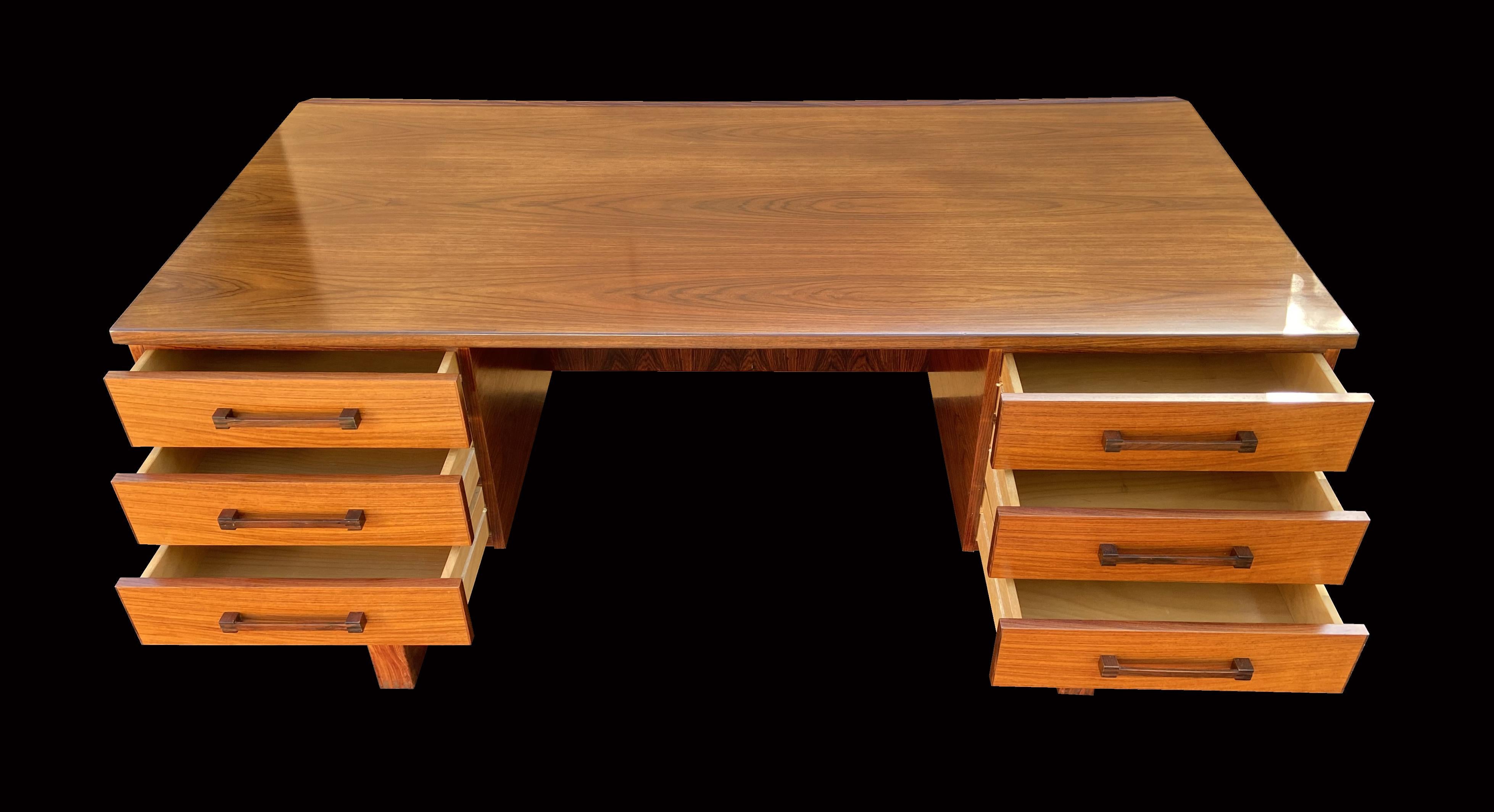 A very nice classic Scandinavian Modern Santos rosewood desk by Torben Valeur and Henning Jensen
Santos rosewood (Machaerium Scleroxylon) is not on the Cites list, so there is no problem with import or export.