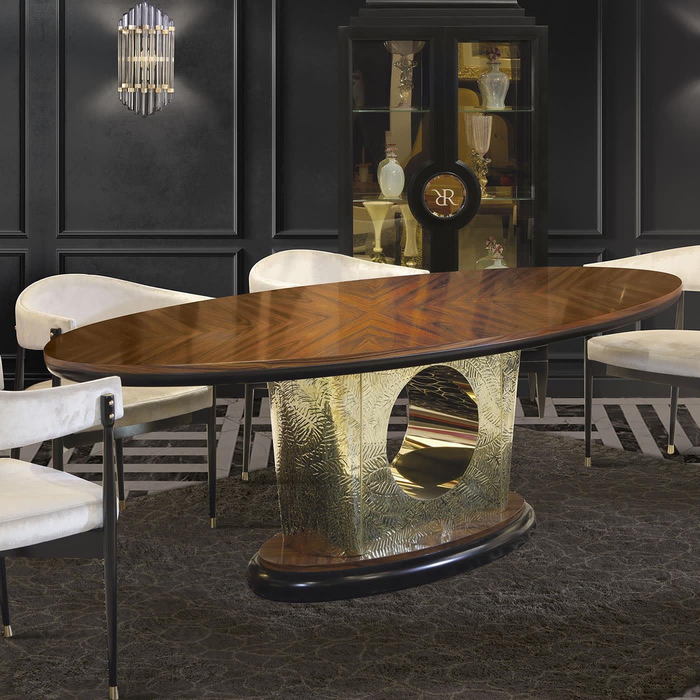 A statement of undoubted opulence, this oval dining table will take center stage in exclusive interior decors. Interposed between the stately oval top and the coordinated base - both fashioned of prized Santos rosewood and enriched with black