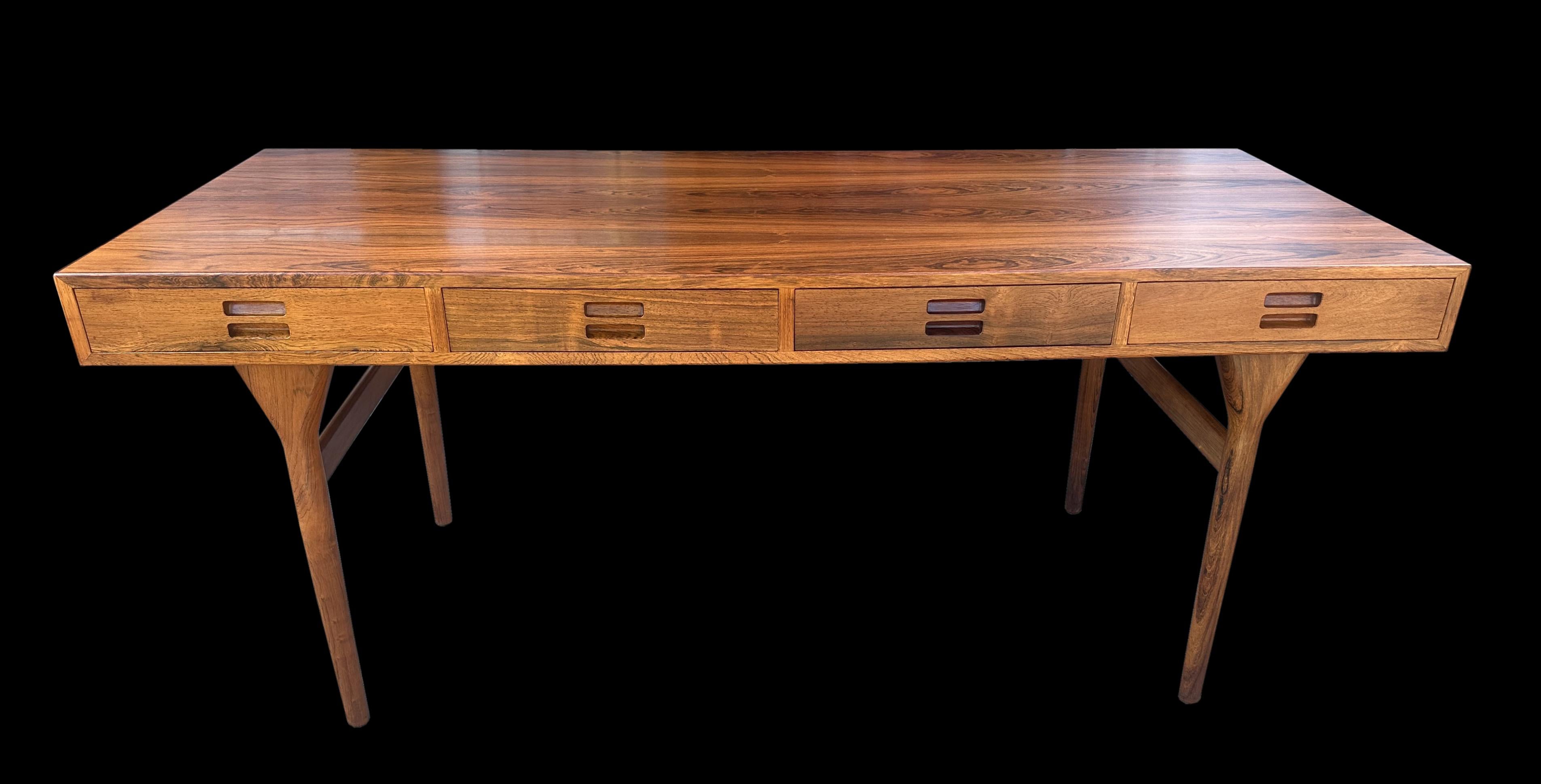 This original 4 drawer writing table by Nanna Ditzel is in very good condition, as with the vast majority of desks and writing tables from Scandinavia at this time, it had always had a blotter on the top from new and although this protects the top