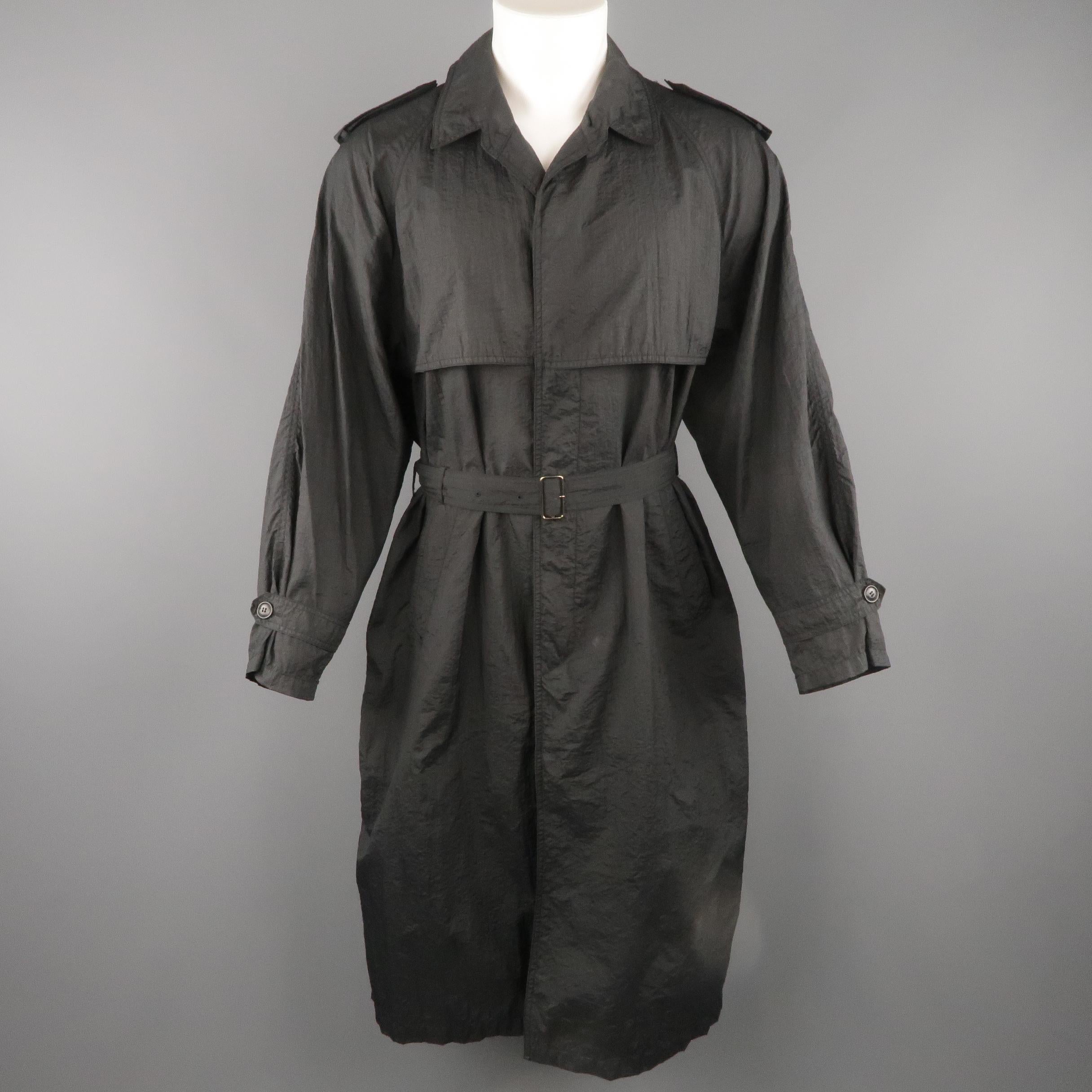 SANYO trench coat comes in black wrinkle textured nylon with a pointed collar, storm flap, epaulets, raglan sleeves with tab cuffs, hidden placket button closure front, and belted waist.
 
Very Good Pre-Owned Condition.
Marked: (no size)
