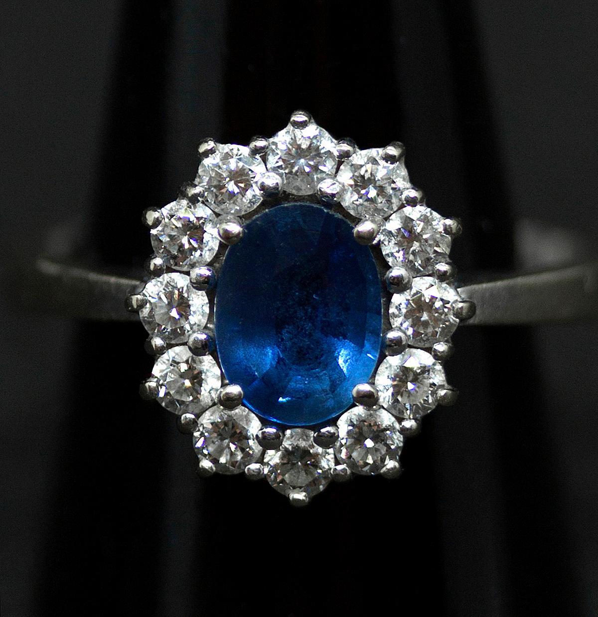 Classic oval-shaped sapphire and brilliant-cut diamonds ring with a centered facetted saphire, surounded by round brilliant-cut diamonds estimated to weigh a total of 1.0 carat, claw set in a white gold mount.
 
Austria, circa 1960

head measuring 