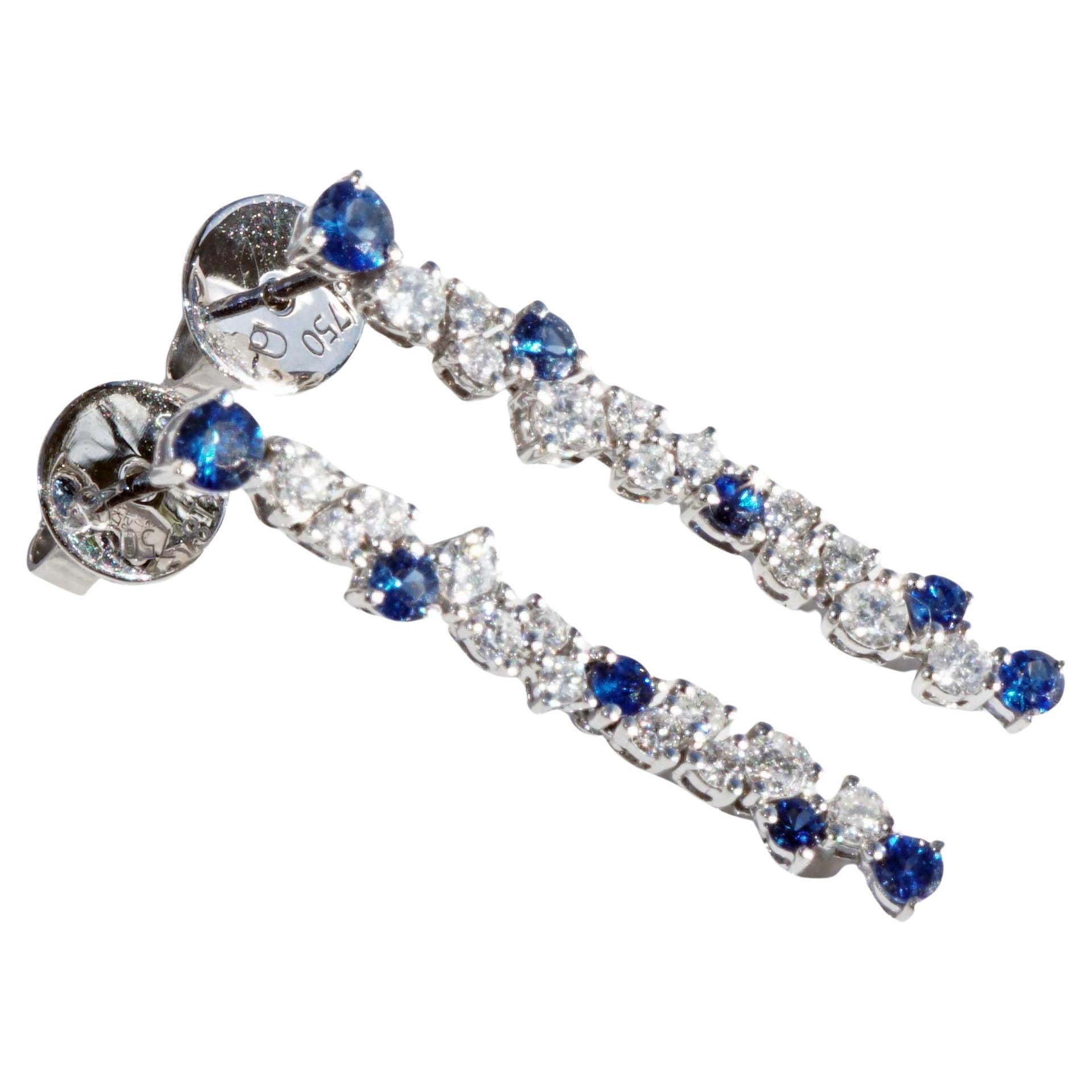 enchanting earrings for a glorious appearance in linear arrangement with staggered set saphires and brilliant-cut diamonds, 10 round-faced fine saphires total approx. 0.50 ct, 24 small and larger full-cut brilliant-cut diamonds total approx. 0.56