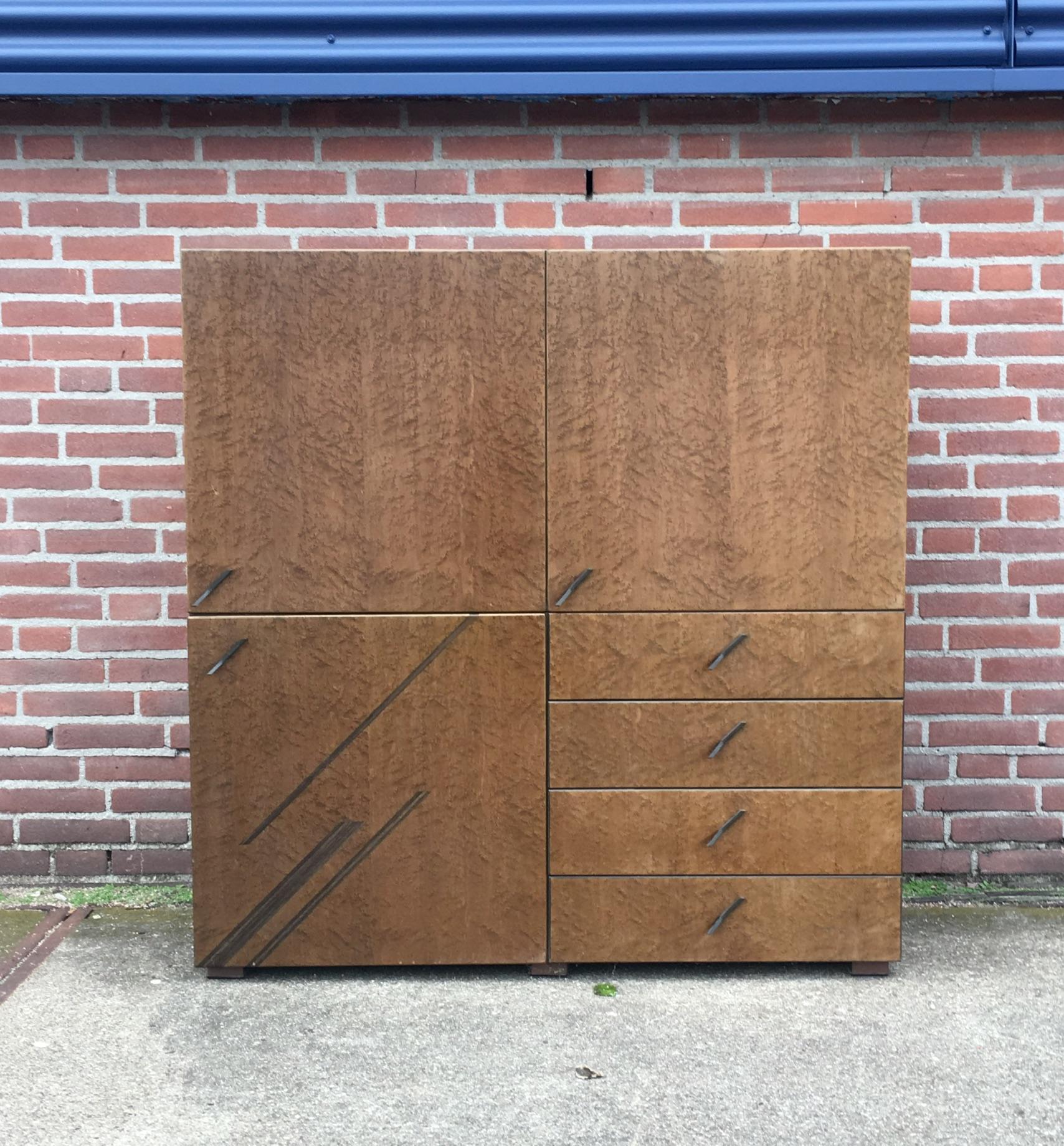 Wonderful Saporiti Higboard, manufactured in Italy. It consists of two pieces, a drawer piece and an upstanding piece with two doors. Both pieces have a shelve Inside. This cabinet remains in good condition but shows overall wear like some scratches