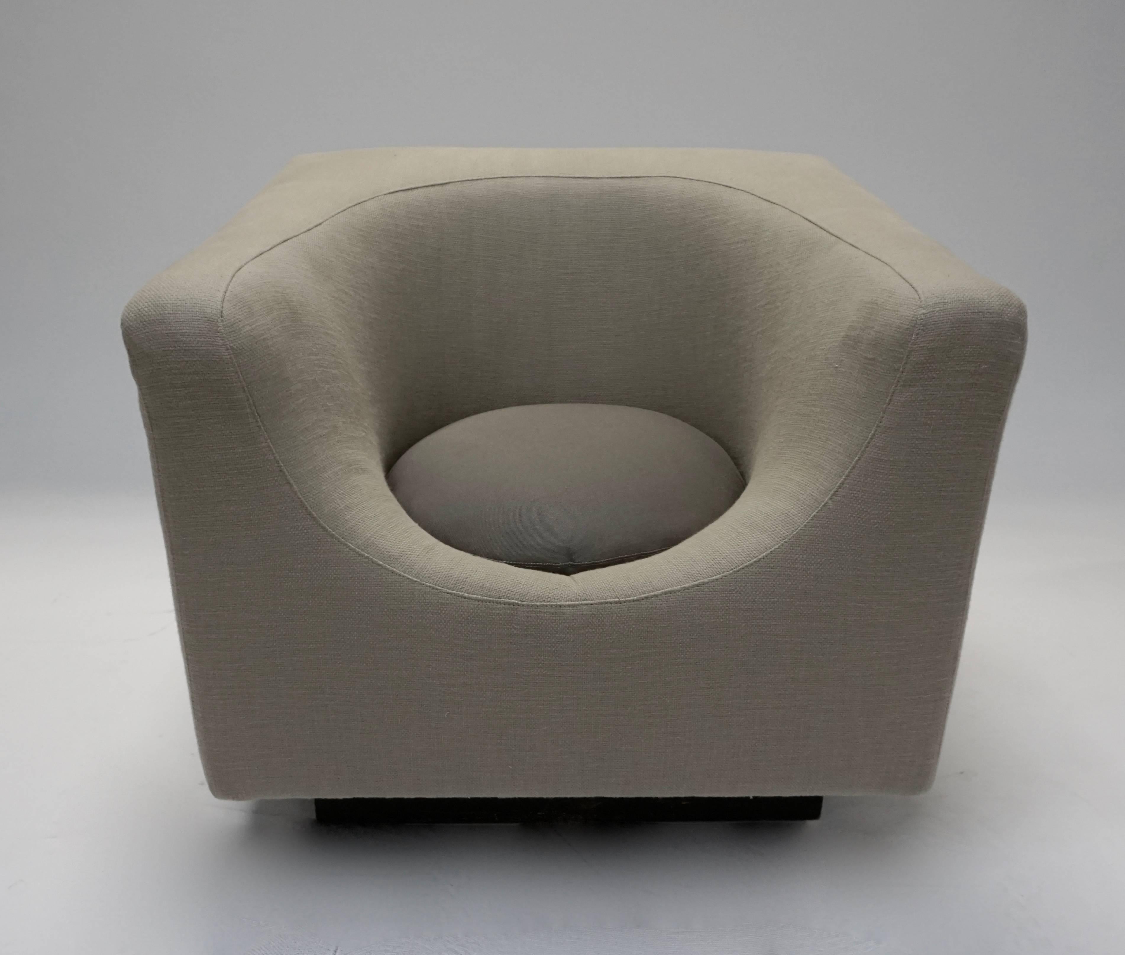 Saporiti chair with the ottoman all redone in new light grey-beige fabric on the main body, and a darker grey on the pillows. Heavy chair and ottoman are both on wheels concealed under the black painted wood bases. Circular pillows are not perfectly