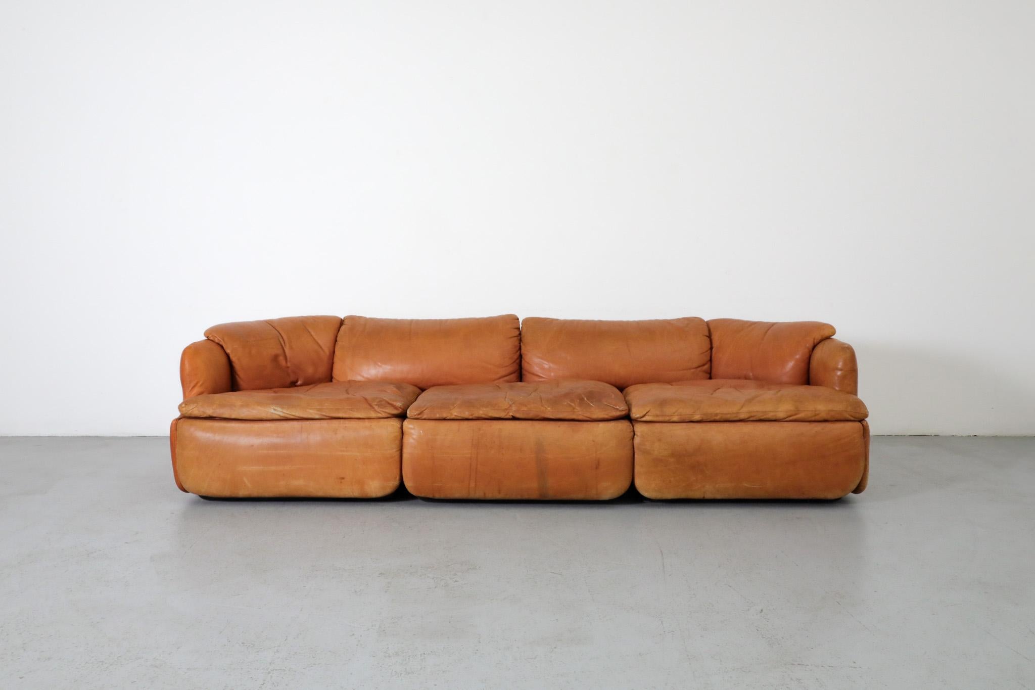 Saporiti 'Confidential' cognac leather sofa by Alberto Rosselli. This luxury 3 seater sofa with nappa leather and polyurethane injected foam cushions brings timeless design to any space. Designed in 1972, the Confidential Collection is one of the