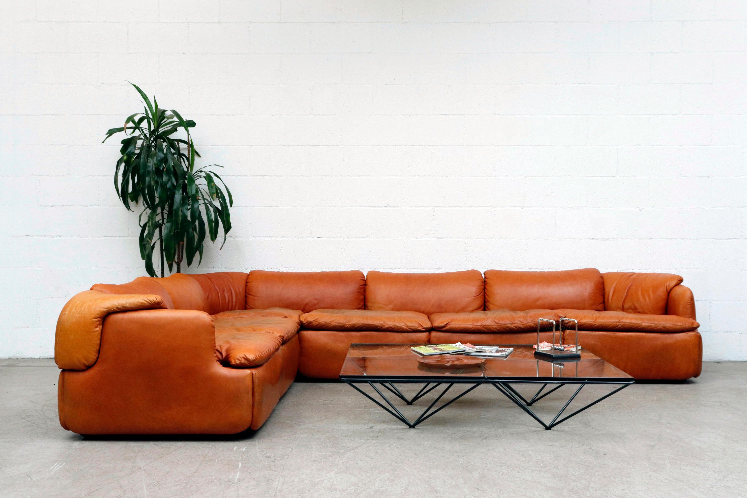 Incredible midcentury Alberto Rosselli 'Confidential' sofa for Saporiti, Italia. Burnt orange leather sectional with puzzle piece cushions. Color touch-up to seat cushion tops, in otherwise original condition with visible wear and patina.