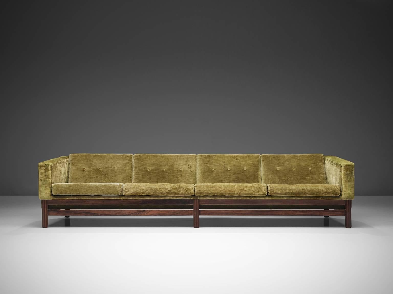 Saporiti, four-seat sofa, green velvet and rosewood, Italy, 1960s. 

The sofa is designed in order to give it that very distinguished long and low look. Loose cushions on seating and back. The tufted cushions give the long and straight design a