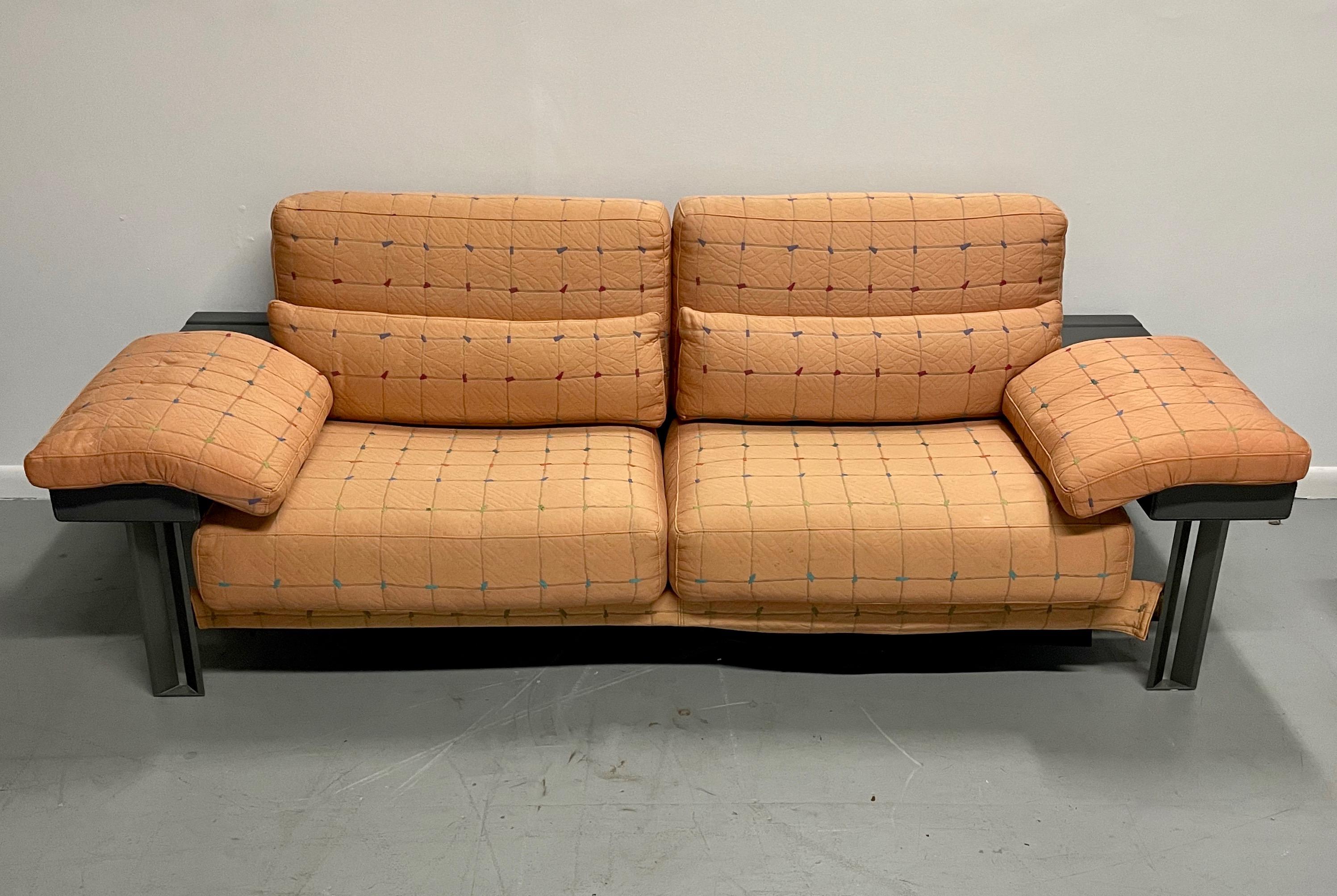 This Saporiti loveseat in it's original fabric is meticulously constructed of stainless steel, burl panels and leather arms and full back. This item needs to be reupholstered. We can reupholster this loveseat in COM. We can also also reconstruct the