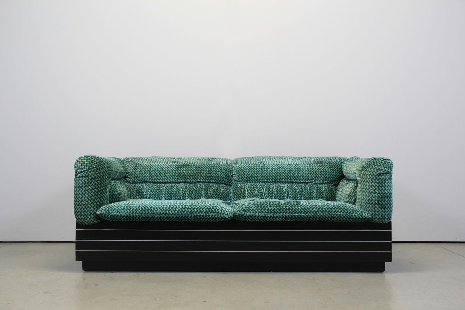 This living room set is manufactured by Saporiti Italia in the 1970s.
It consist a 3-seat sofa and a 2-seat sofa including 1 coffee table.
The fabric is like emerald green.
The black frame from the sofa and table is made of black lacquered wood