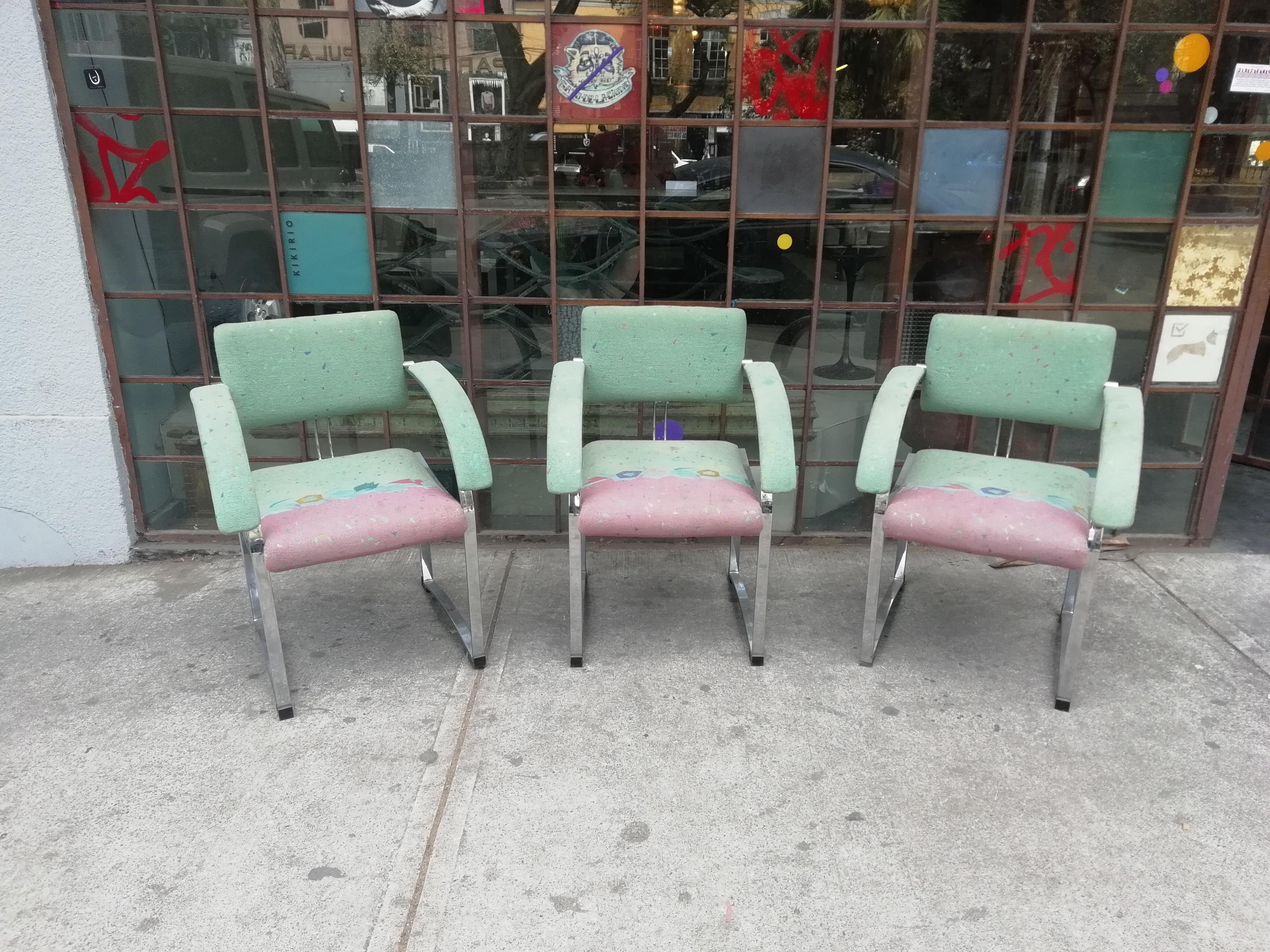 A rare set of 6 chromed steel armchairs by Saporiti Italia. With original upholstery in aqua blue, pink and coral colors. Sold in current vintage condition.