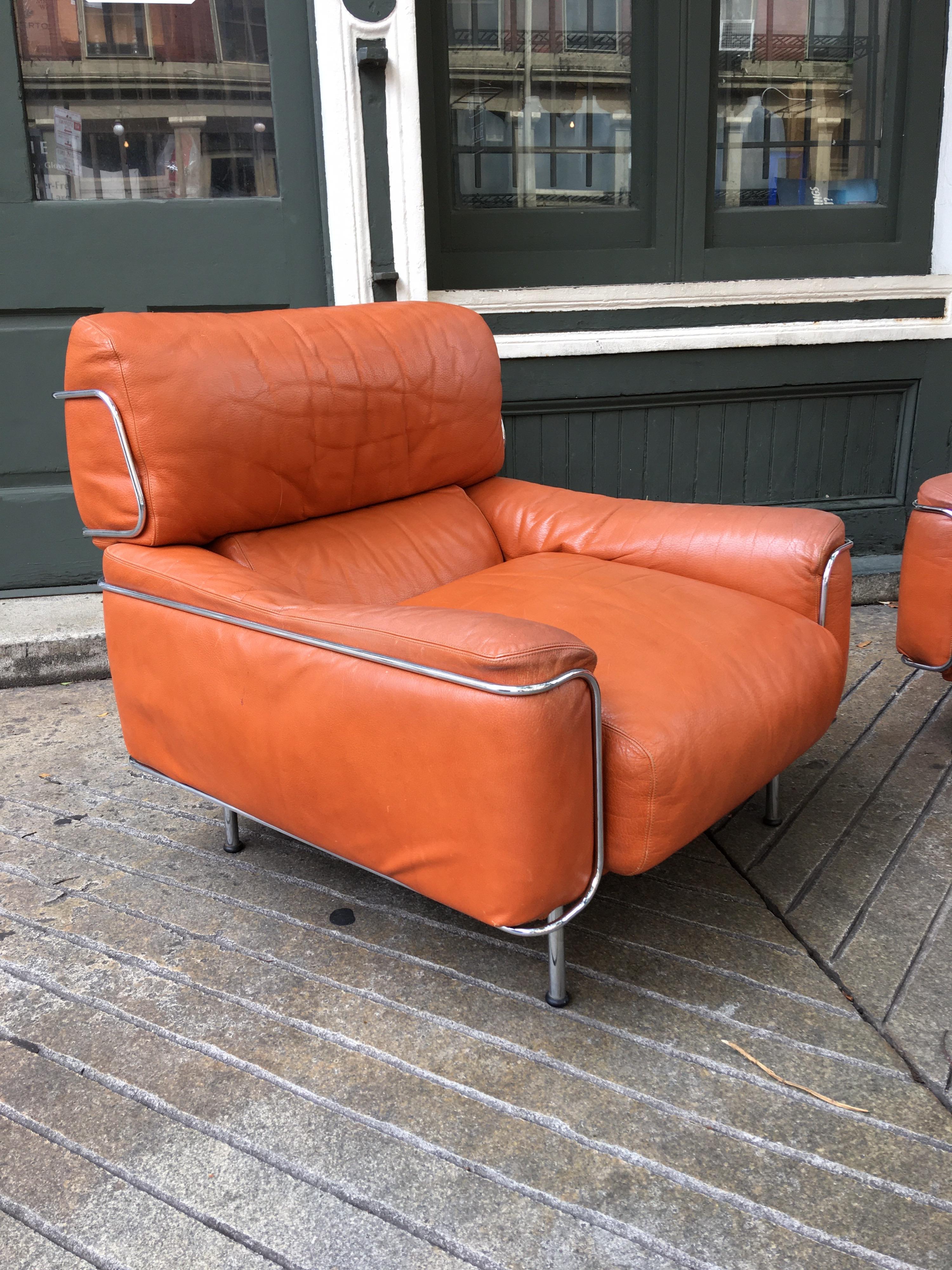 Saporiti leather and chrome lounge chairs with amazing burnt orange leather showing the nicest amount of patina! Probably designed by Sergio Saporiti and Alberto Rosselli in the mid-1960s great low profile! Early Saporiti furniture shows some