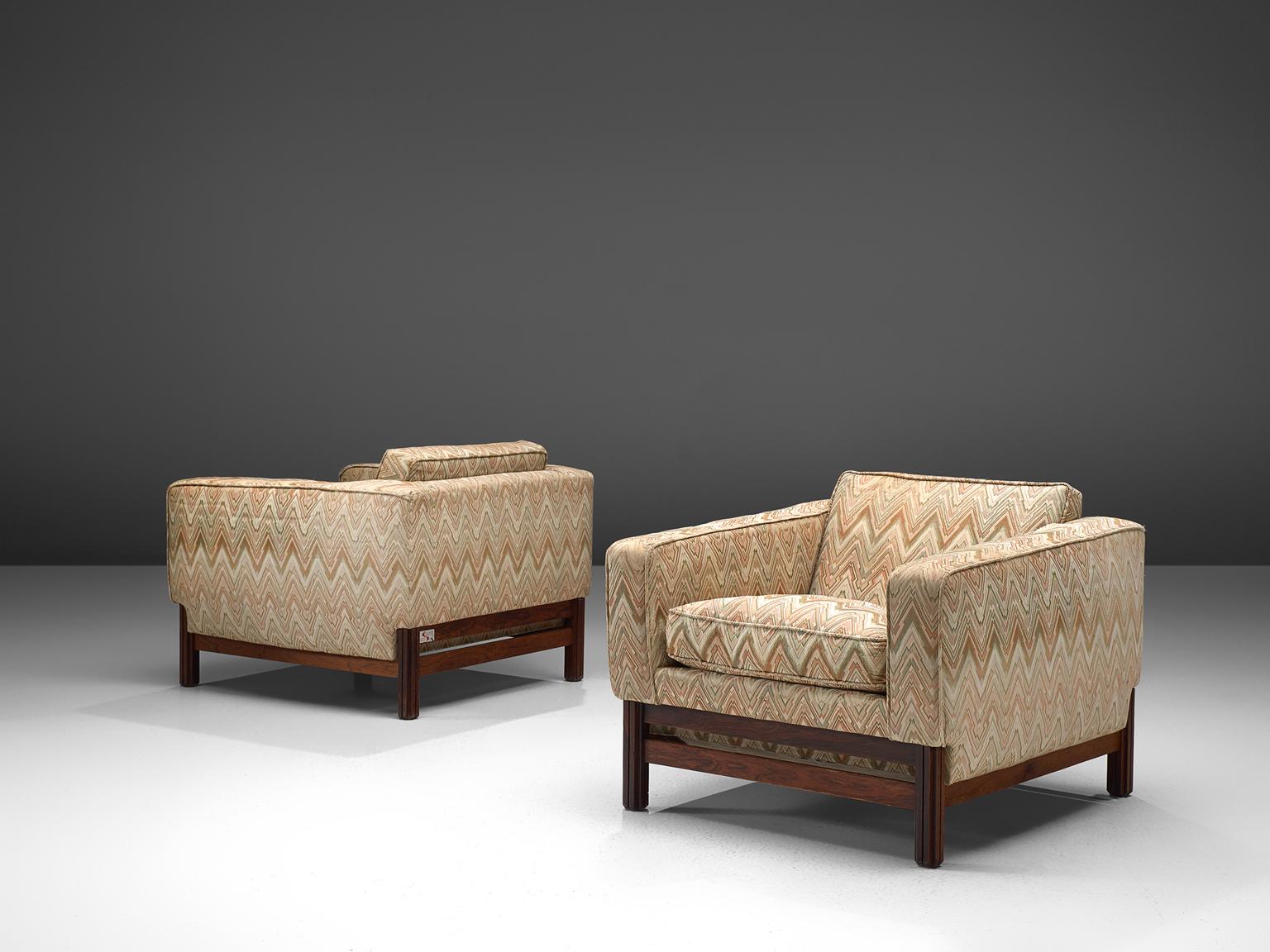 Saporiti, set of two lounge chairs in rosewood and fabric, Italy, 1960s.

These chairs are equipped with a rosewood frame and a retro sand to beige colored upholstery. These chairs are designed in a modest, yet distinguished look. The chairs