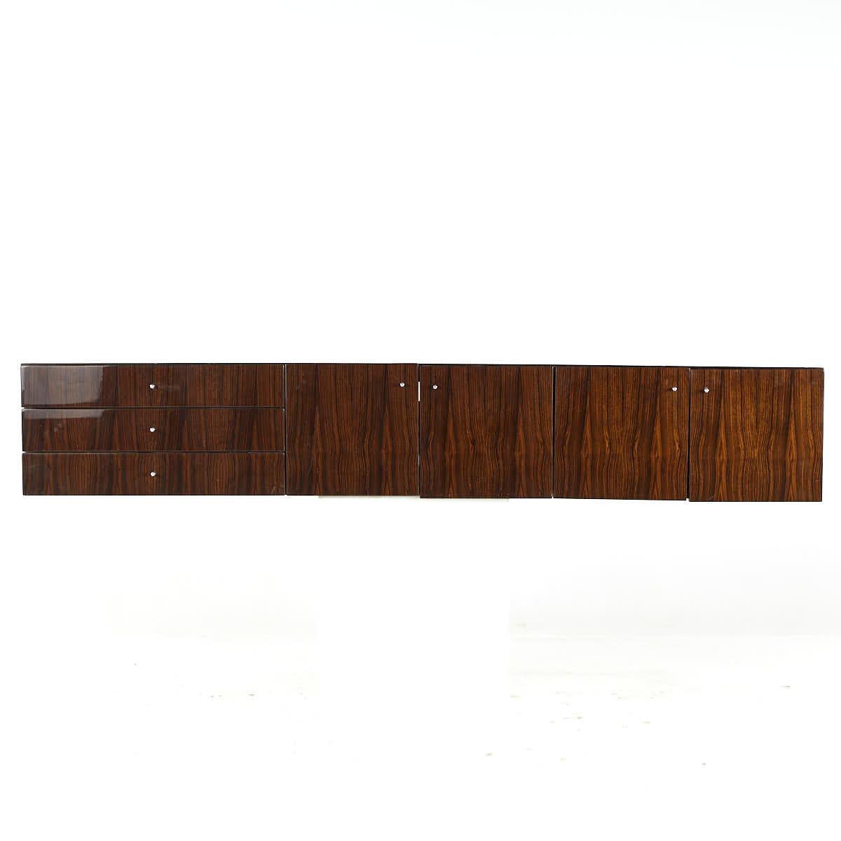 Saporiti Mid Century Italian Rosewood Wall Mounted Hanging Buffet

This buffet measures: 83 wide x 19.75 deep x 14 inches high

All pieces of furniture can be had in what we call restored vintage condition. That means the piece is restored upon