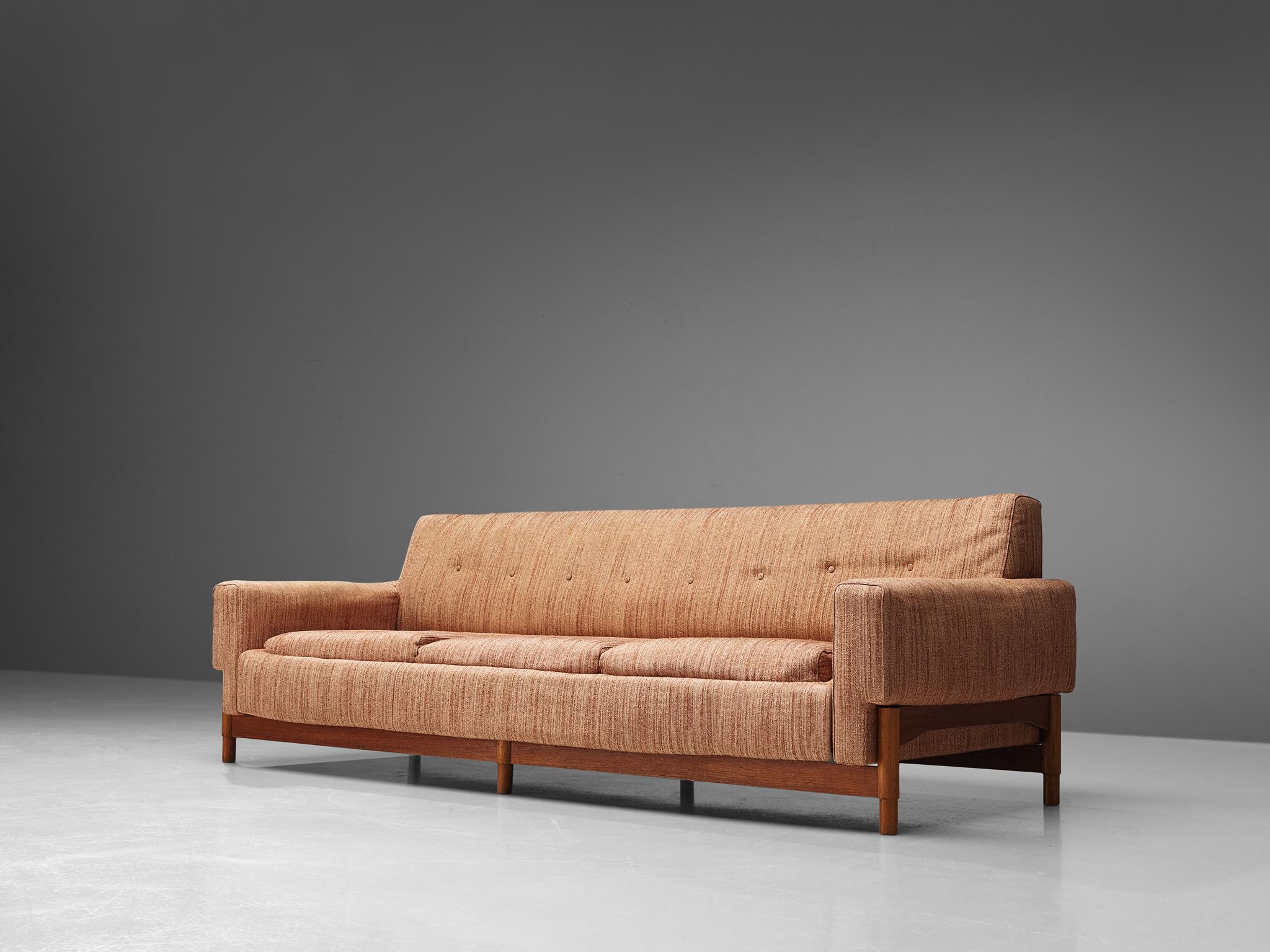 Saporiti, sofa in teak and fabric, Italy, 1960s.

This sofa features a teak frame and a retro salmon colored upholstery. The sofa is designed in a modest, yet distinguished look. The sofa features a balanced aesthetic thanks to the combination of
