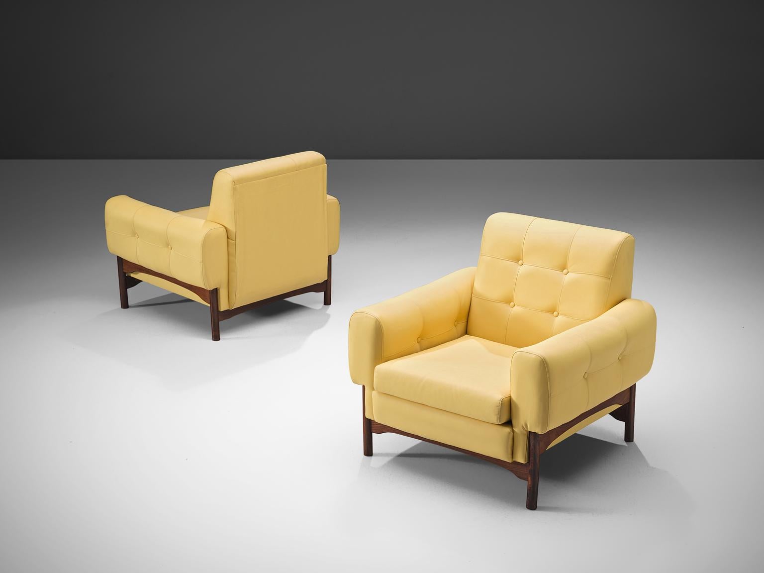 Pair of lounge chairs yellow faux leather upholstery, rosewood, Italy, 1960s.

This elegant, geometric pair of lounge chairs feature a mellow soft yellow faux leather upholstery. The chairs stand on four little tapered wooden legs that support the