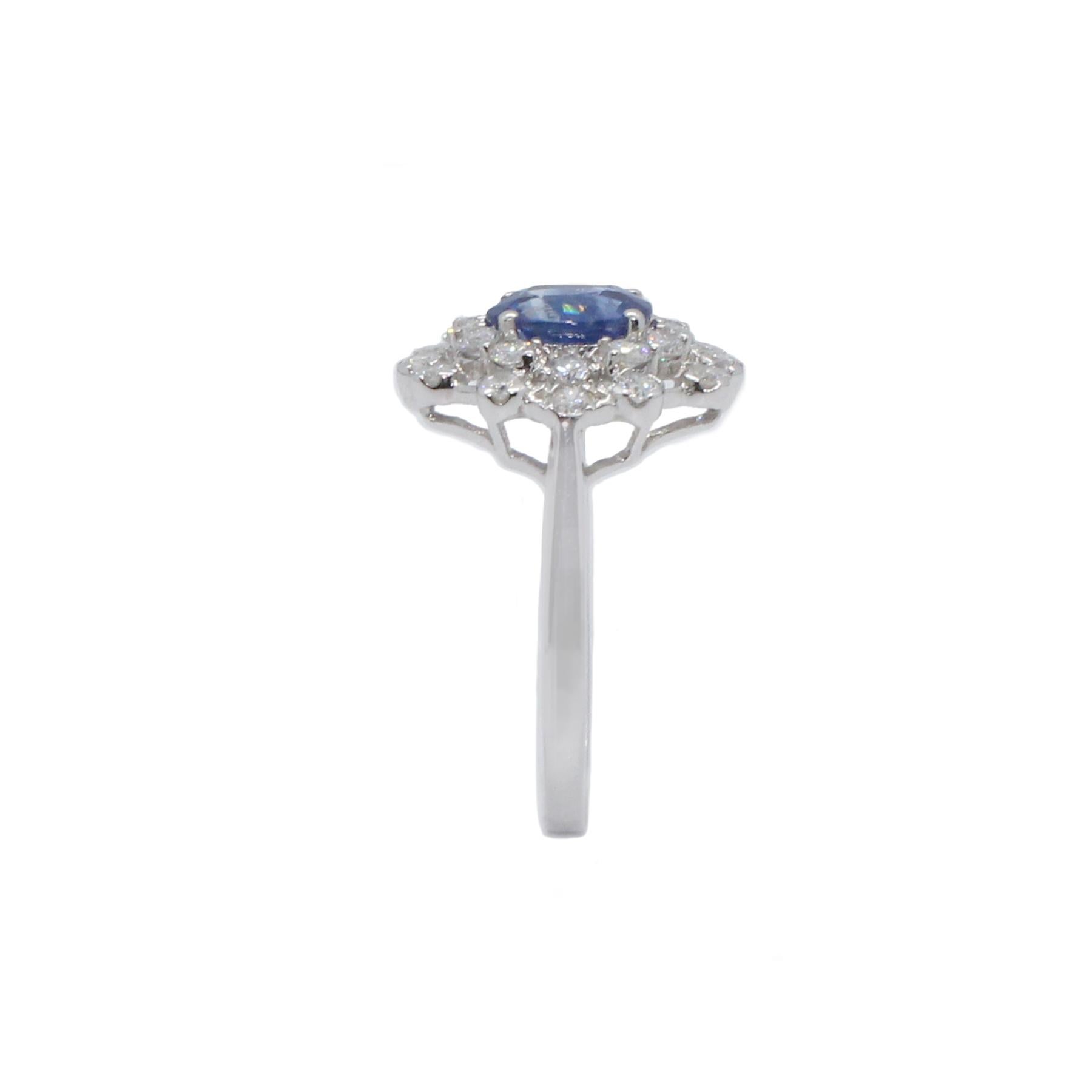 Sapphire diamond cocktail ring. Violatish blue, oval 1.14 carats natural sapphire, mounted in high profile, open basket with four bead prongs, accented with round brilliant cut diamonds. Beautiful handcrafted design set in high polished 18 karat