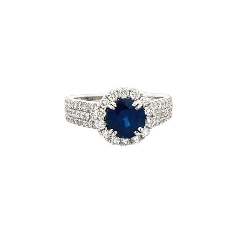 Get ready to be blown away by the breathtaking beauty of this cocktail ring! Featuring a stunning round-shaped blue sapphire in the finest color for this gemstone, this ring boasts a center stone weighing an impressive 1.57 carats. Accompanying the