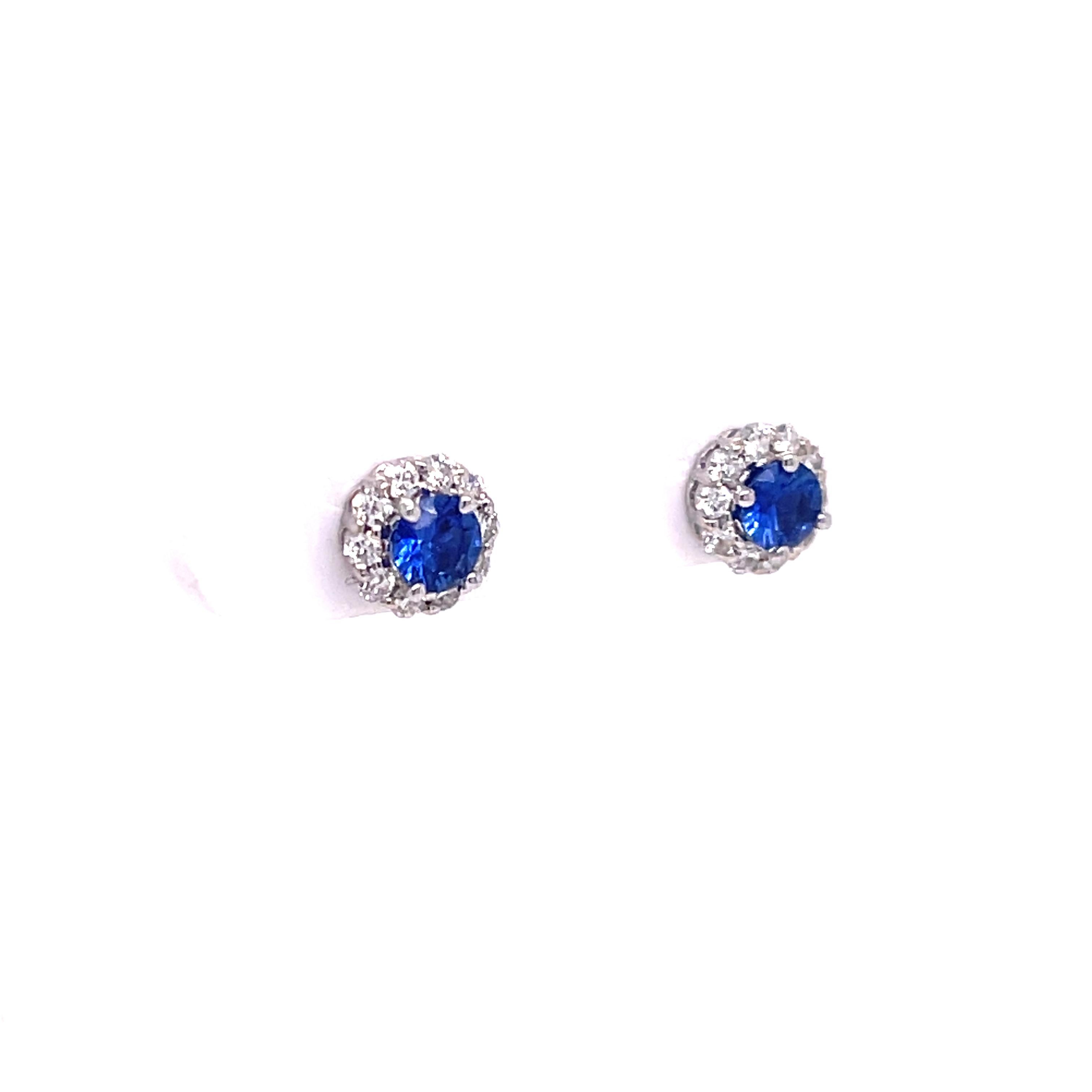 Sapphire and diamond studs in 14K white gold. The earrings feature 0.48ctw of round sapphires with halos of 0.27ctw round diamonds. 