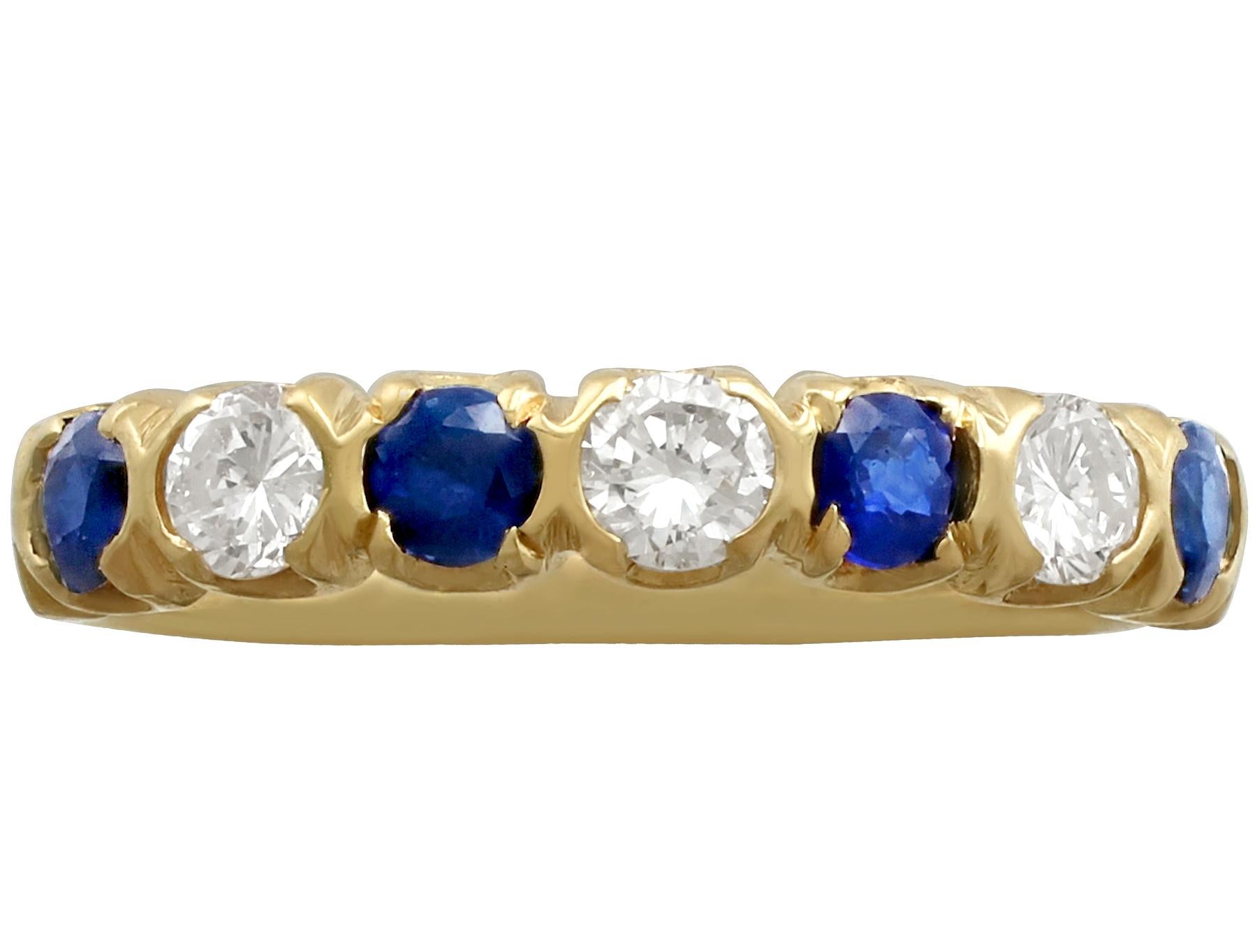 A fine and impressive vintage 0.45 carat blue sapphire and 0.48 carat diamond, 18k yellow gold half eternity ring; part of our vintage jewellery and estate jewelry collections.

This fine and impressive sapphire and diamond eternity ring has been