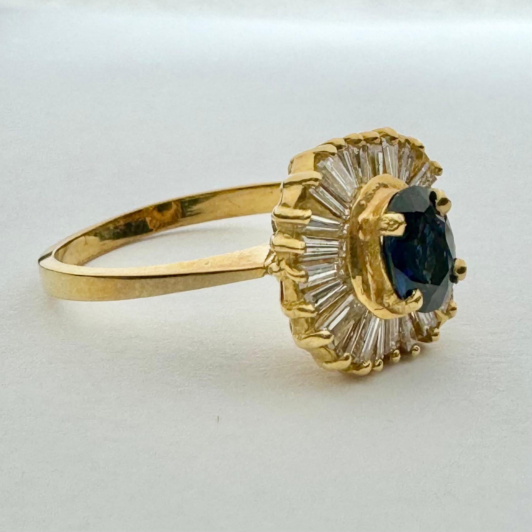 Beautiful vintage sapphire and and diamond ring in 18k yellow gold.
Surrounding a beautiful rich blue sapphire are dazzling tapered baguette diamonds, delicately arranged in a gorgeous and dynamic halo, similar to the rise and fall of a ballerina's
