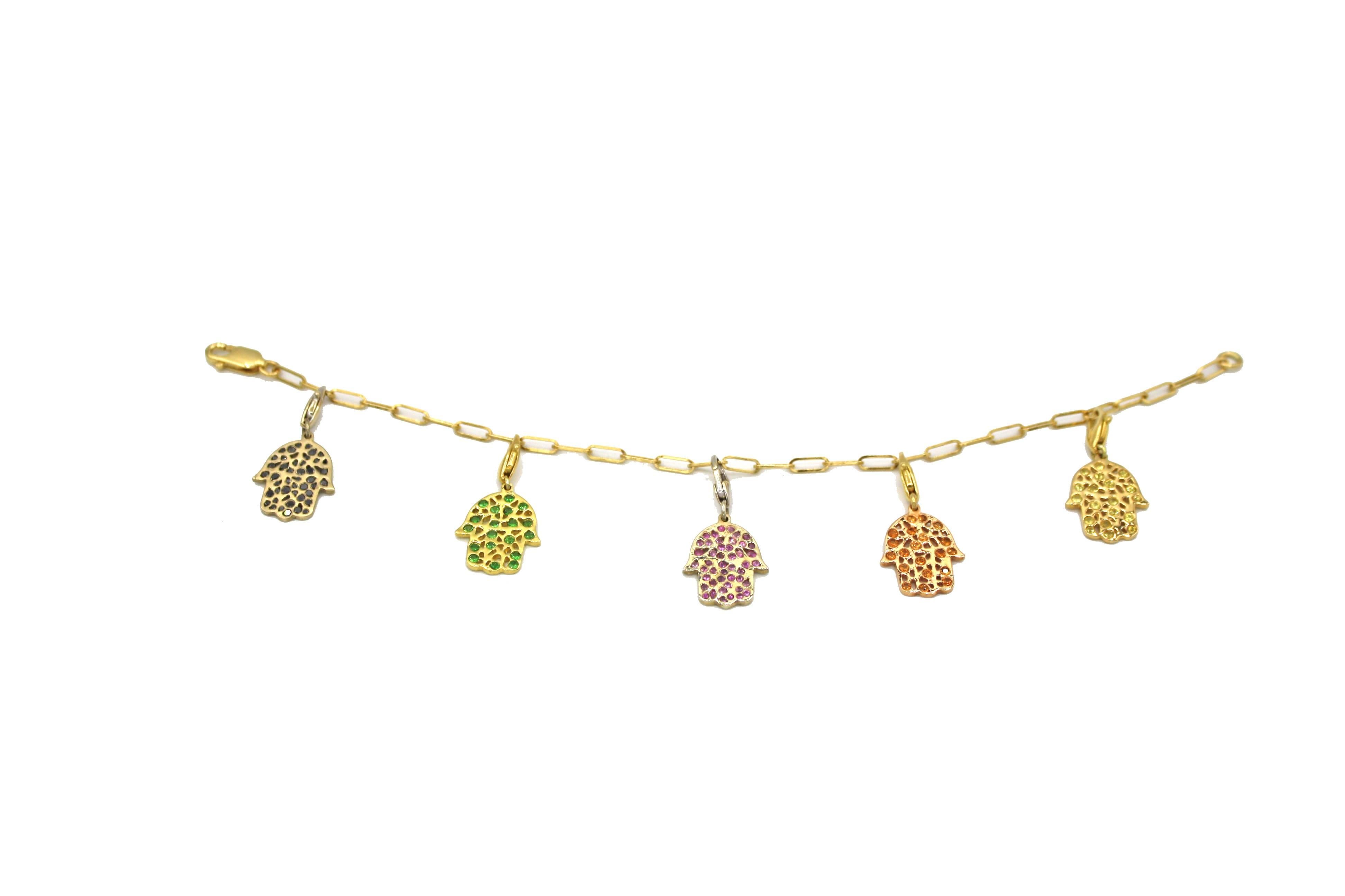 This chic 18k gold charm bracelet includes 5 white and yellow gold Hamsa hand charms with Pink, Yellow, Green, and Orange Sapphires as well as one with Black Diamonds. Each charm is removable and can be rearranged however the wearer would like.